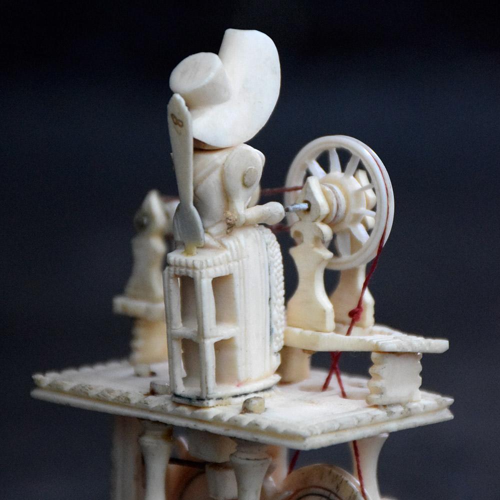 Napoleonic prisoner of war spinning jenny
We are proud to offer a rare mechanized carved bone model of a spinning jenny. The upper platform has a seated female figure in a hat at a spinning wheel. Lower platform with hand crank and wheels that