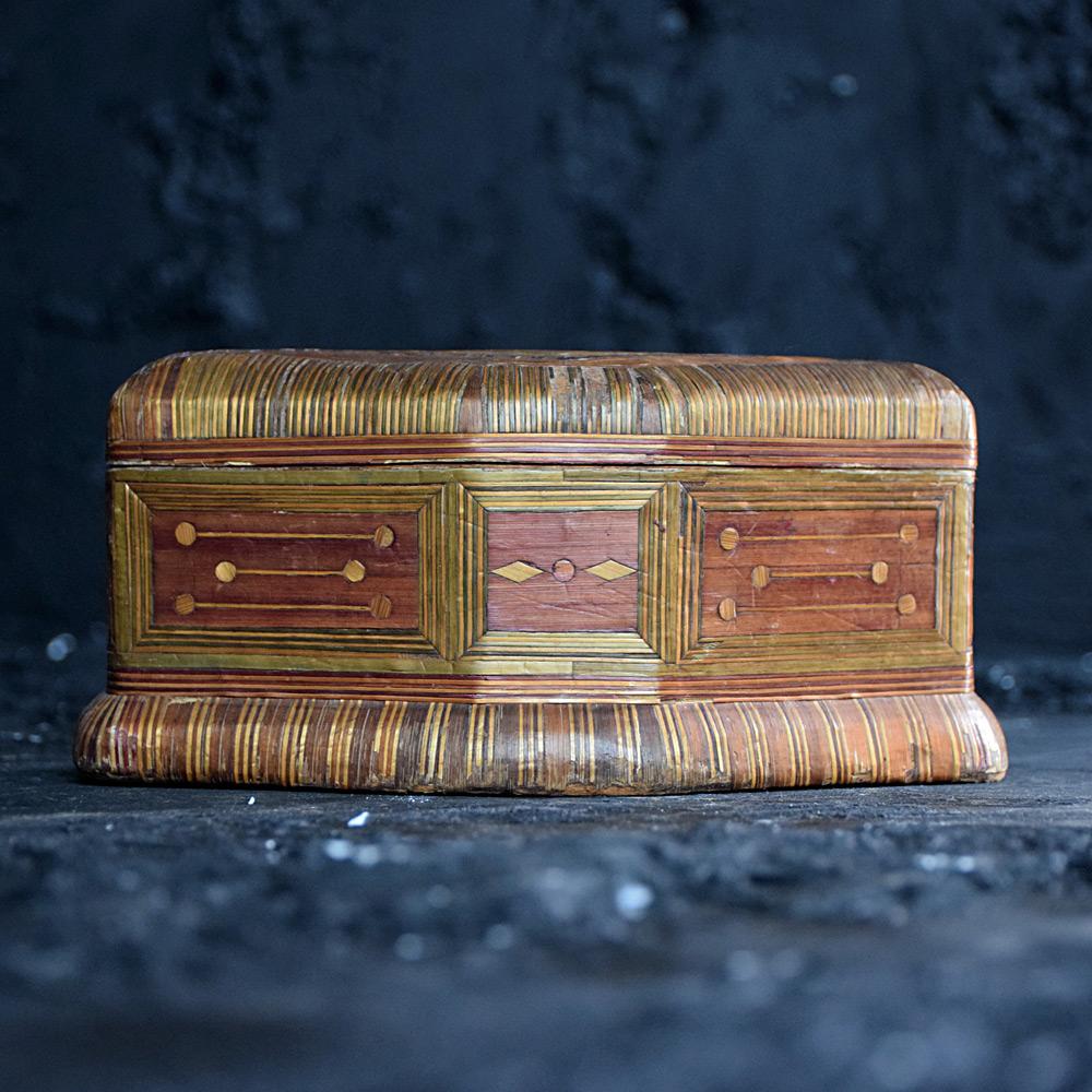 Napoleonic prisoner of war straw work box 

A very fine antique Napoleonic prisoner of war straw work box, made from two sections of a lined base and lid which fit together perfectly. A colour staining to the applied straw work designs which also