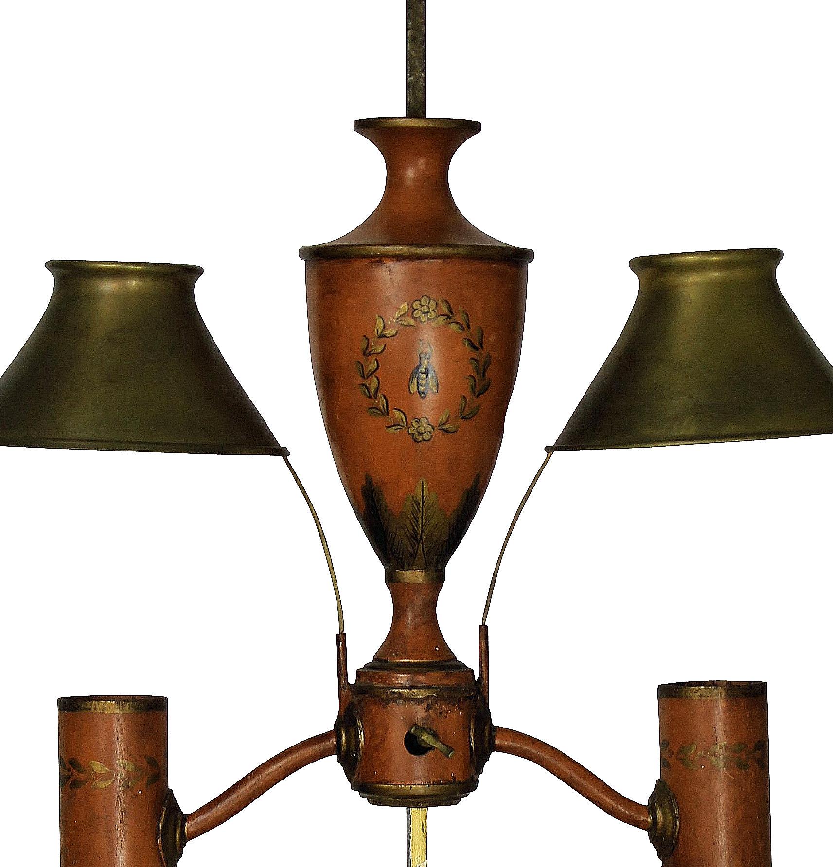 A French Napoleon III hand painted tole desk lamp in orange and gold leaf, with adjustable brass shades. In the Napoleonic revival style, depicting bees.
 
 