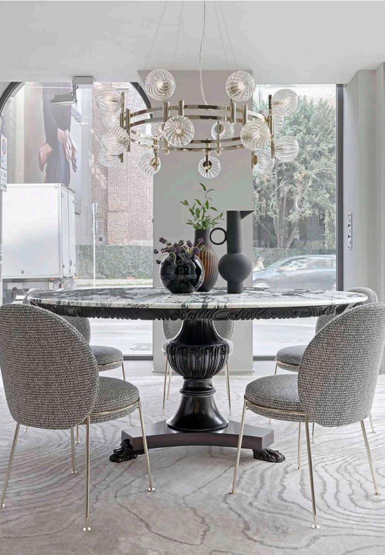 Napoleonic Style round table in hand carved solid wood. Featuring a column leg 
resting on a single uniform base with three catpaw feet.
Available in black patinated finish with Viola Calacatta marble top.