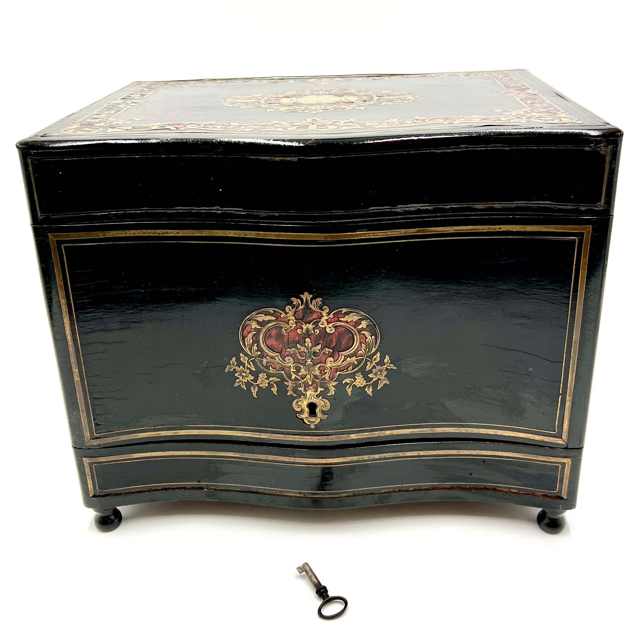 Presenting an exquisite antique French Tantalus liquor cabinet that transports you back to the elegance of the mid to late 1800s. This remarkable piece has been crafted in the sophisticated Napoleon III style, showcasing ebonized wood, intricate