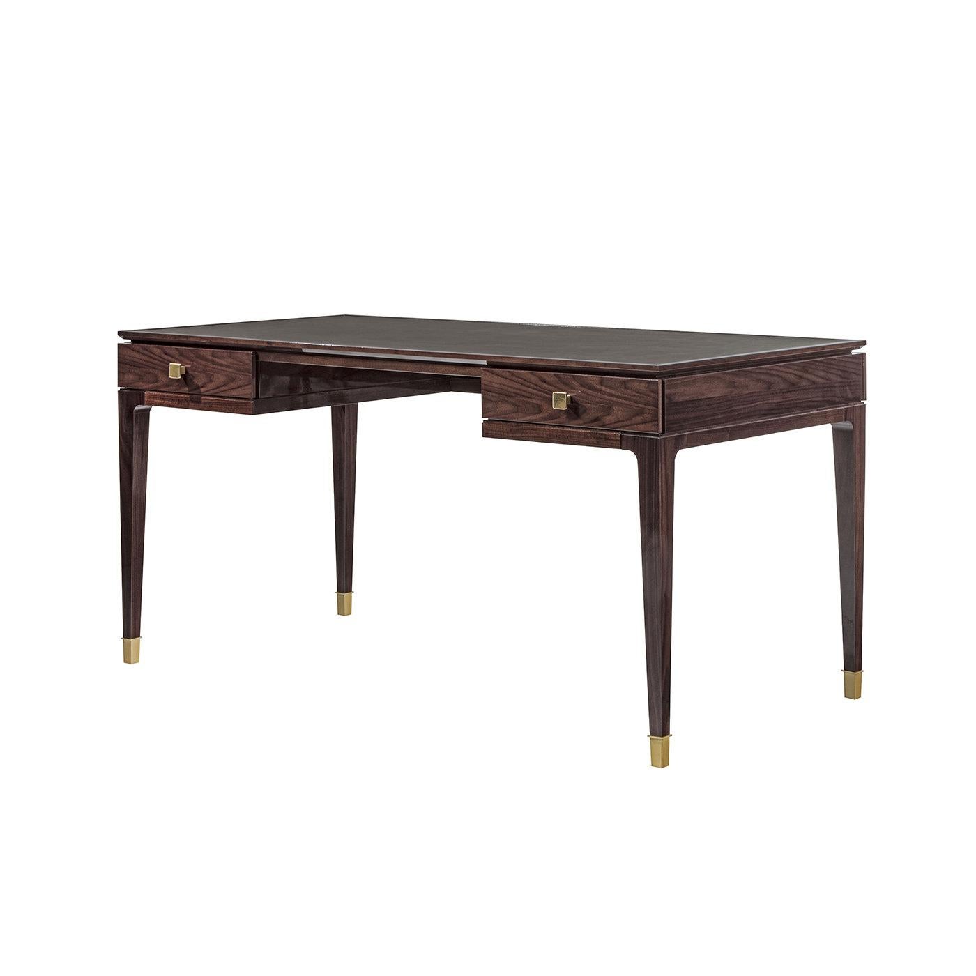 This desk was inspired by traits of Art Deco and architecture typical of the Japanese city of Nara. Its graceful frame in glossy, tobacco-finished walnut boasts slender, tapered legs with brass caps and sustains the topping panel in prized leather.