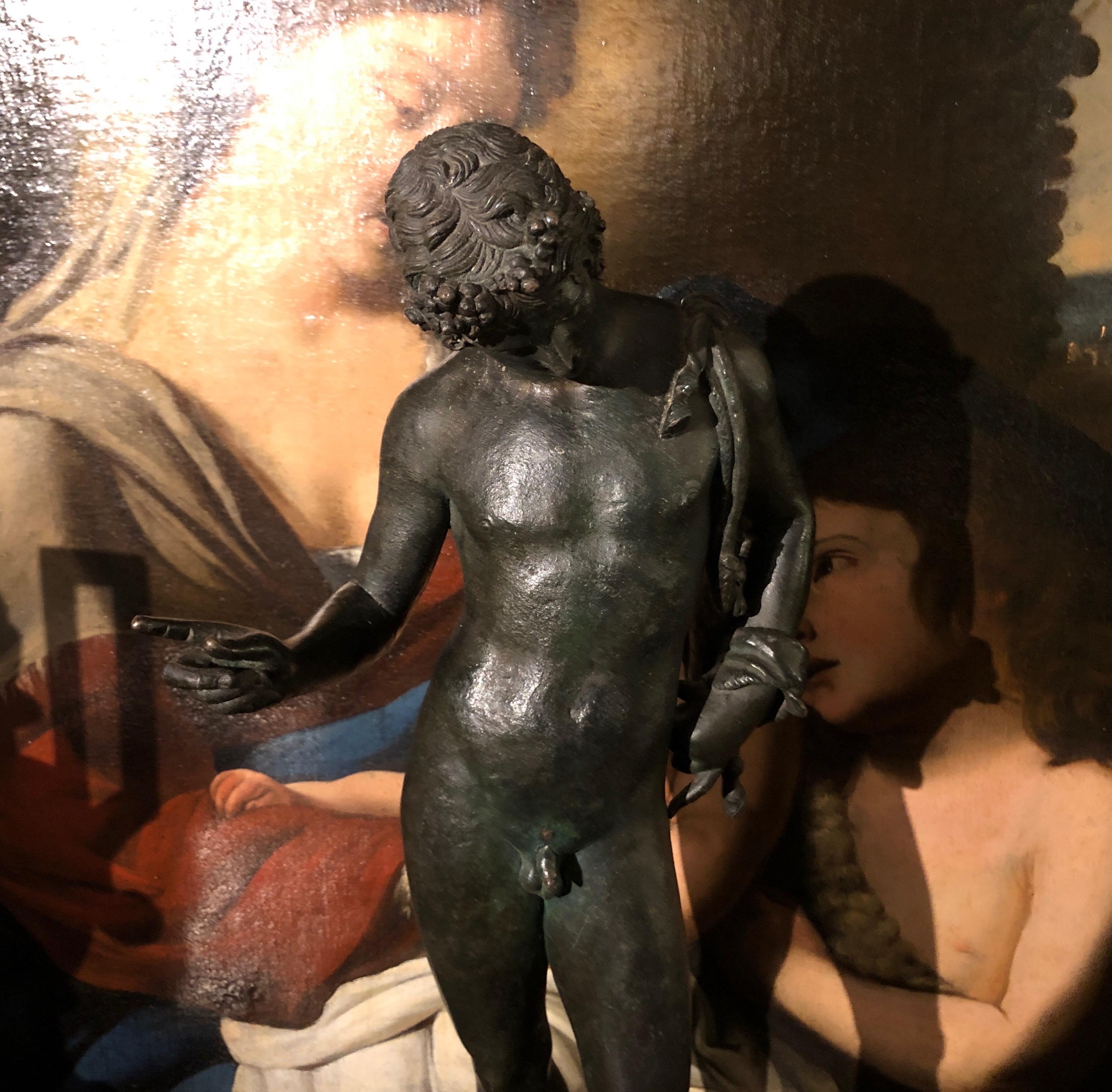 Narcissus Bronze Sculpture early 1900s,  the figure is a reproduction from the classical-era bronze of the Greek god Dionysus found in the 1862 excavations at Pompeii and preserved at the National Archaeological Museum in Naples. Dark patina earth