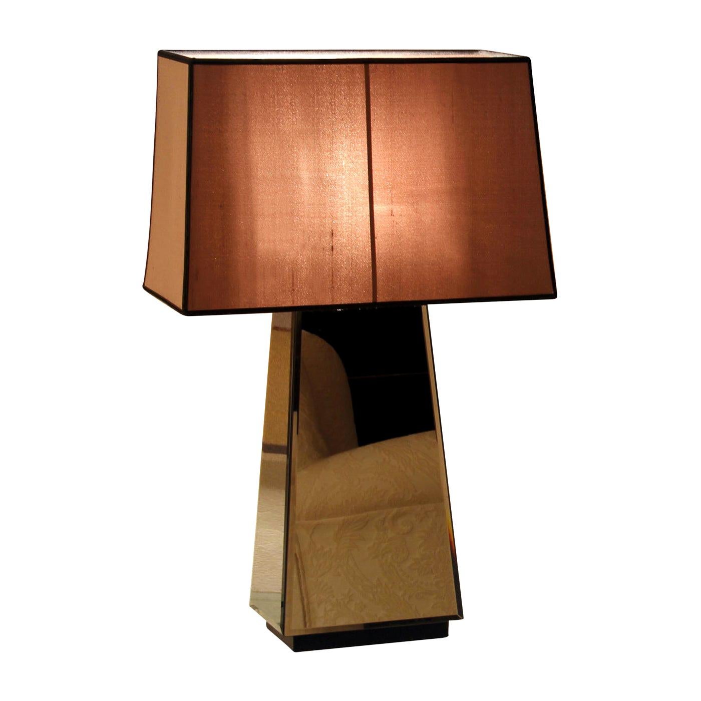 A stunning accessory, with a contemporary design, the Narciso M Table Lamp features a structure covered in smoked bevelled mirror that combines perfectly with the base in wood and lampshade in cotton-linen fabric.\nBulbs: 1 x max 60W E27, 1 x 20W