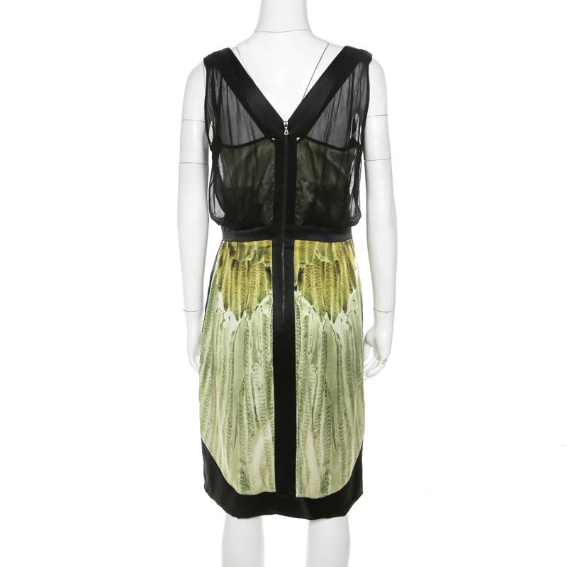 This Narciso Rodriguez dress, masterfully tailored from quality fabrics, is a reflection of feminine fashion. It is designed with colours of green and black, a back zipper and mesh overlay. The dress is the right fusion of sophistication and comfort