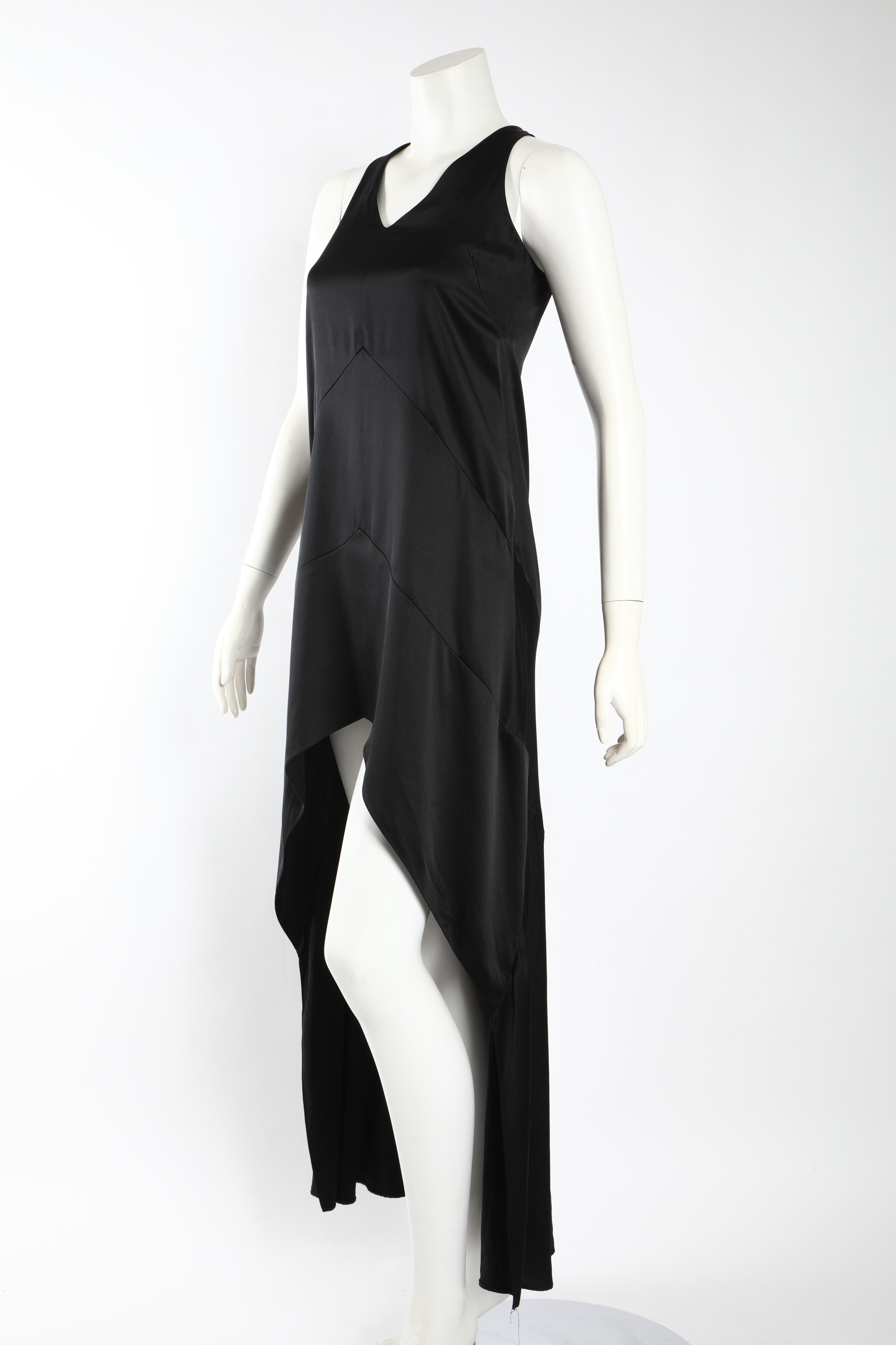 Simple black silk slip dress by Narciso Rodriguez with an extreme high-low hem and v-neck.  A simple and chic addition to any wardrobe. Size 4. 