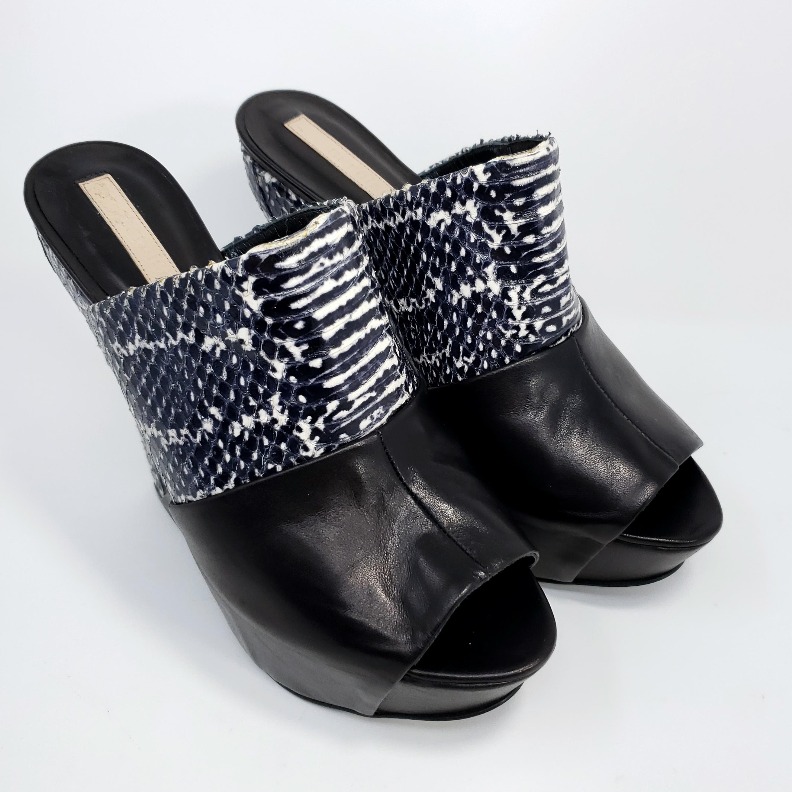  omen's wedge sandals by Narciso Rodriguez. This stylish shoe features black and white snakeskin and leather upper.

US 7.5, EU 37.5
Heel height: 5.5 in / 14 cm
Made in Italy

Good condition with gentle, minimal wear. Comes with original box and