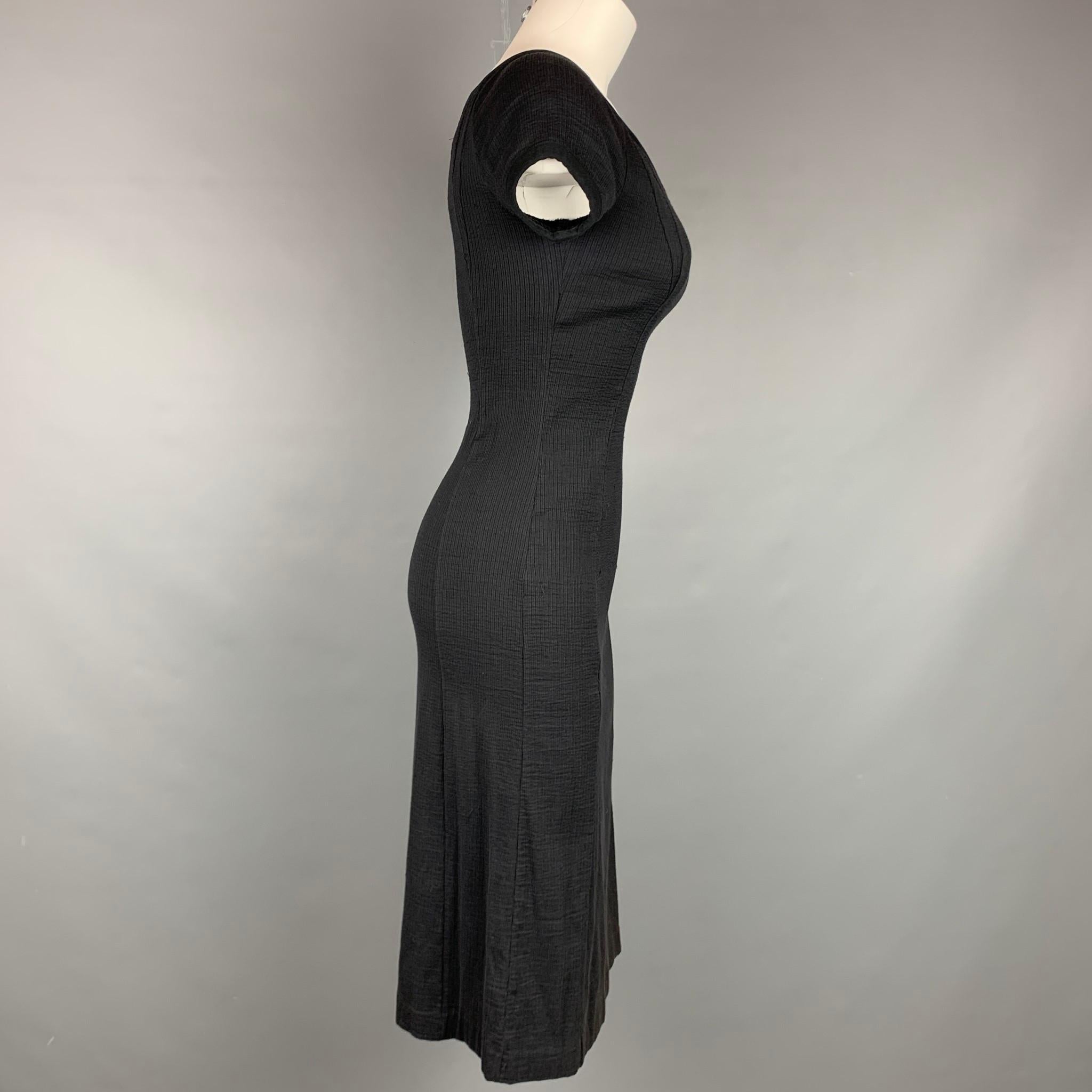 NARCISO RODRIGUEZ dress comes in a black ribbed cotton / polyamide featuring short sleeves and a v-neck. Made in Italy.

Very Good Pre-Owned Condition.
Marked: I 38 / F 34 / D 34 / GB 6 / USA 2

Measurements:

Shoulder: 10 in.
Bust: 30 in.
Waist: 26