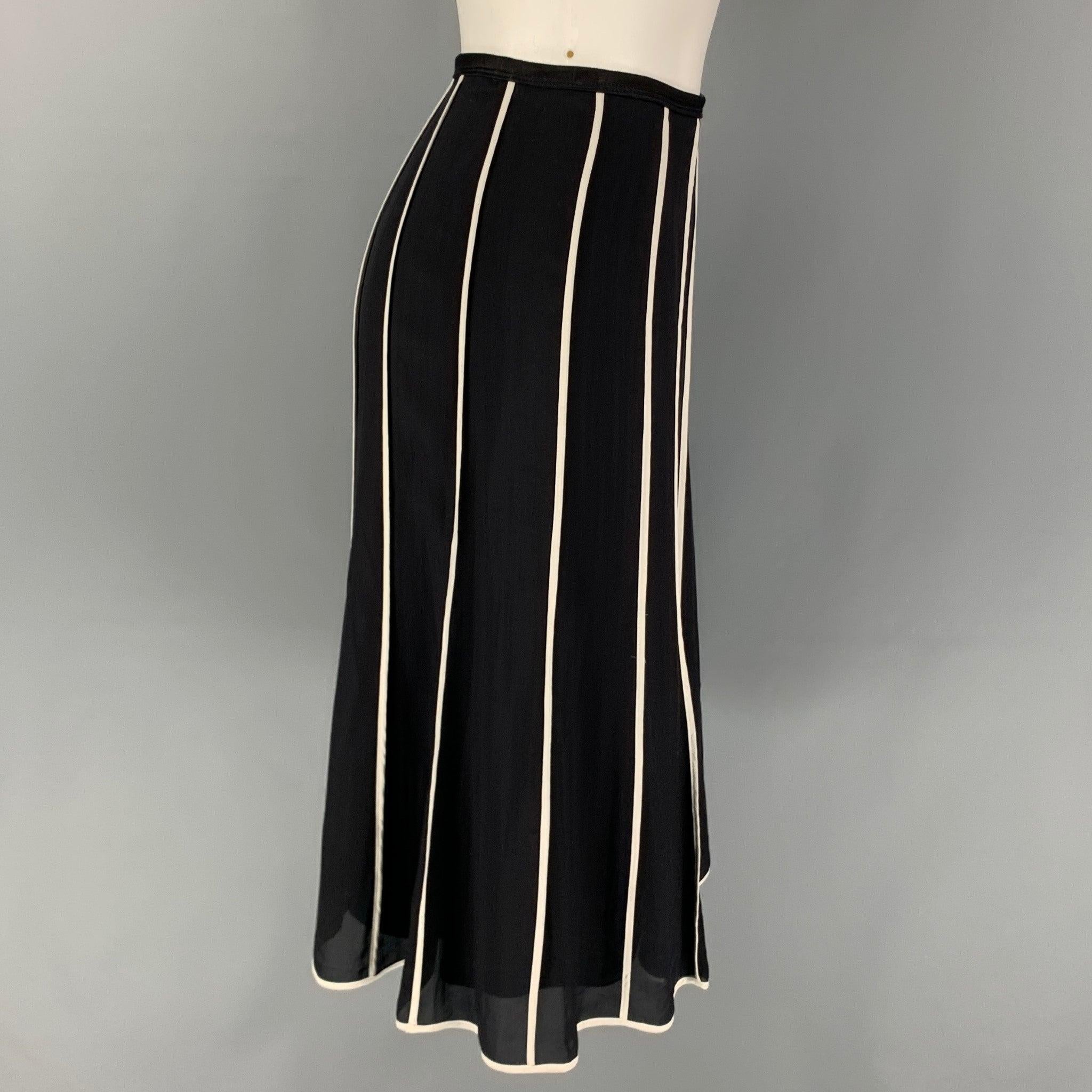 NARCISO RODRIGUEZ skirt comes in a black & white stripe silk featuring an a-line style and a side zipper closure. Made in Italy.
Very Good
Pre-Owned Condition. 

Marked:   I 40 / F 36 / D 36 / GB 8 / USA 4 

Measurements: 
  Waist: 28 inches  Hip: