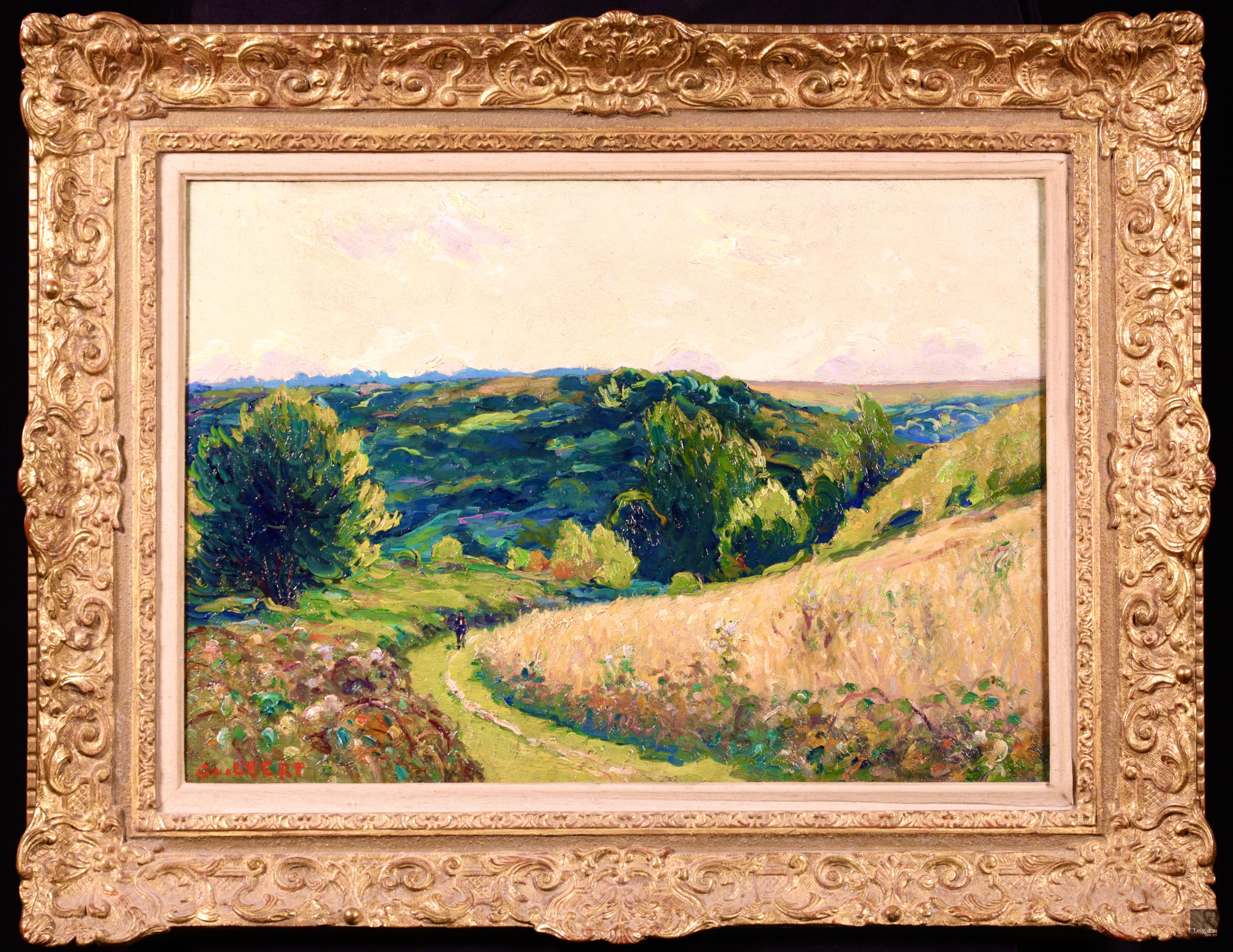 Signed post impressionist figure in landscape oil on canvas circa 1930 by French painter Narcisse Guilbert. The work depicts a lone man walking in the afternoon sun up a grassy path through fields of long grass and vast green trees and bushes in La