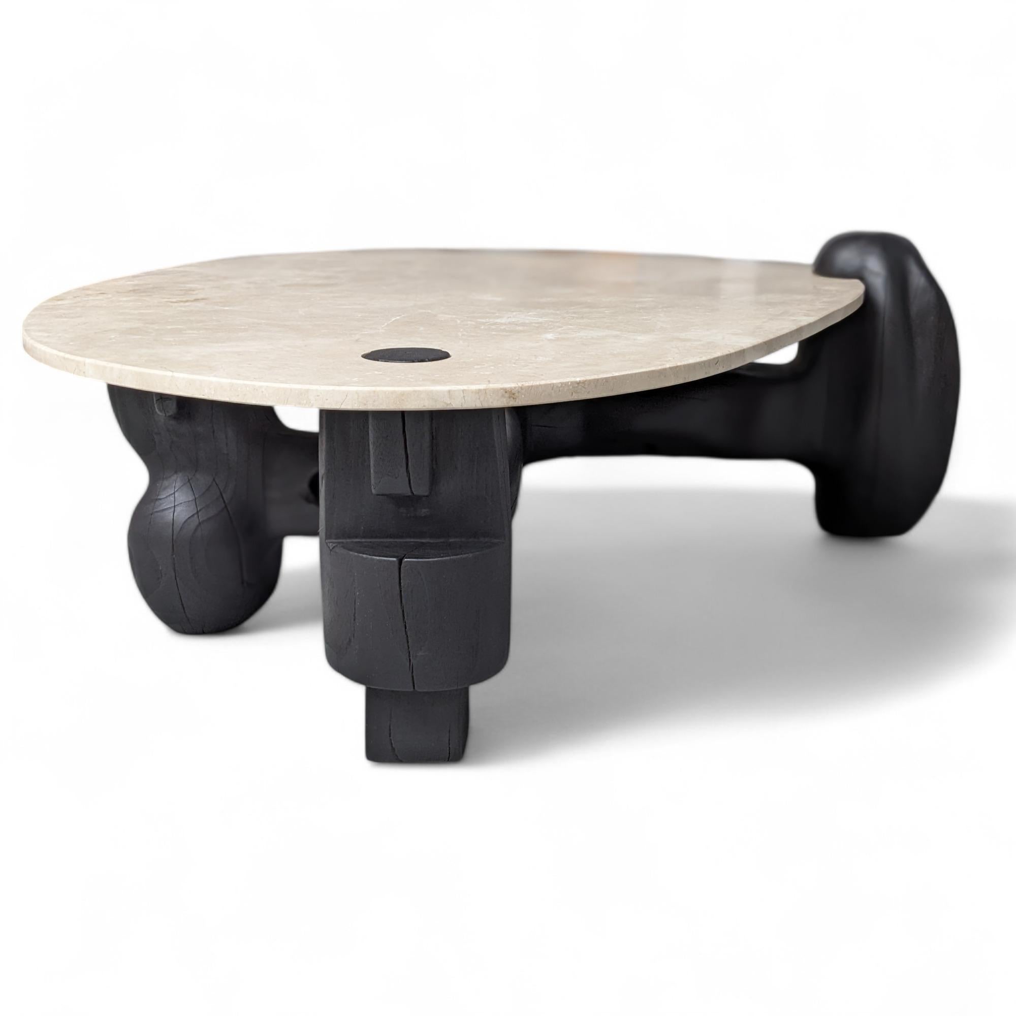Tavolo da centro Narco Teak Collection'S di AMBER x IÑIGO CALLEJA
Dimensioni: L 160 x P 120 x H 45 cm. 
Materiali: Base in tronchi di teak secco, carbonizzato e tinto di nero pece, piano in marmo crema avorio, finitura opaca.

Iñigo Calleja è un