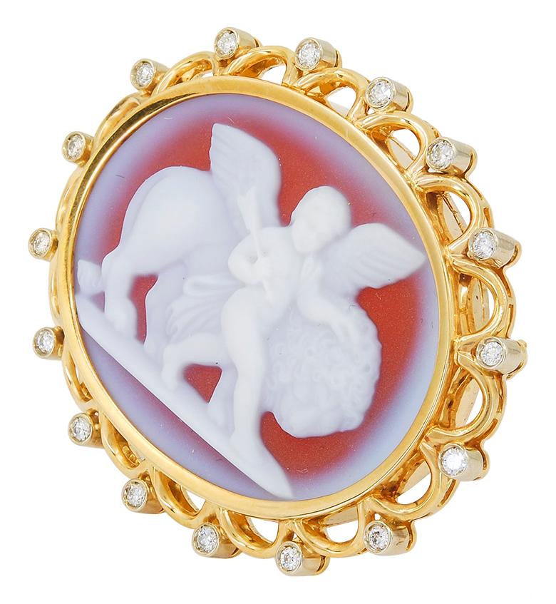 Nardi Love Conquers All Cameo Brooch in 18k Yellow Gold.

An Italian two-toned cameo brooch by Nardi featuring a gold scalloped halo, finished with meticulously-spaced round diamonds that frame the outer edge. Although this cameo dates from the