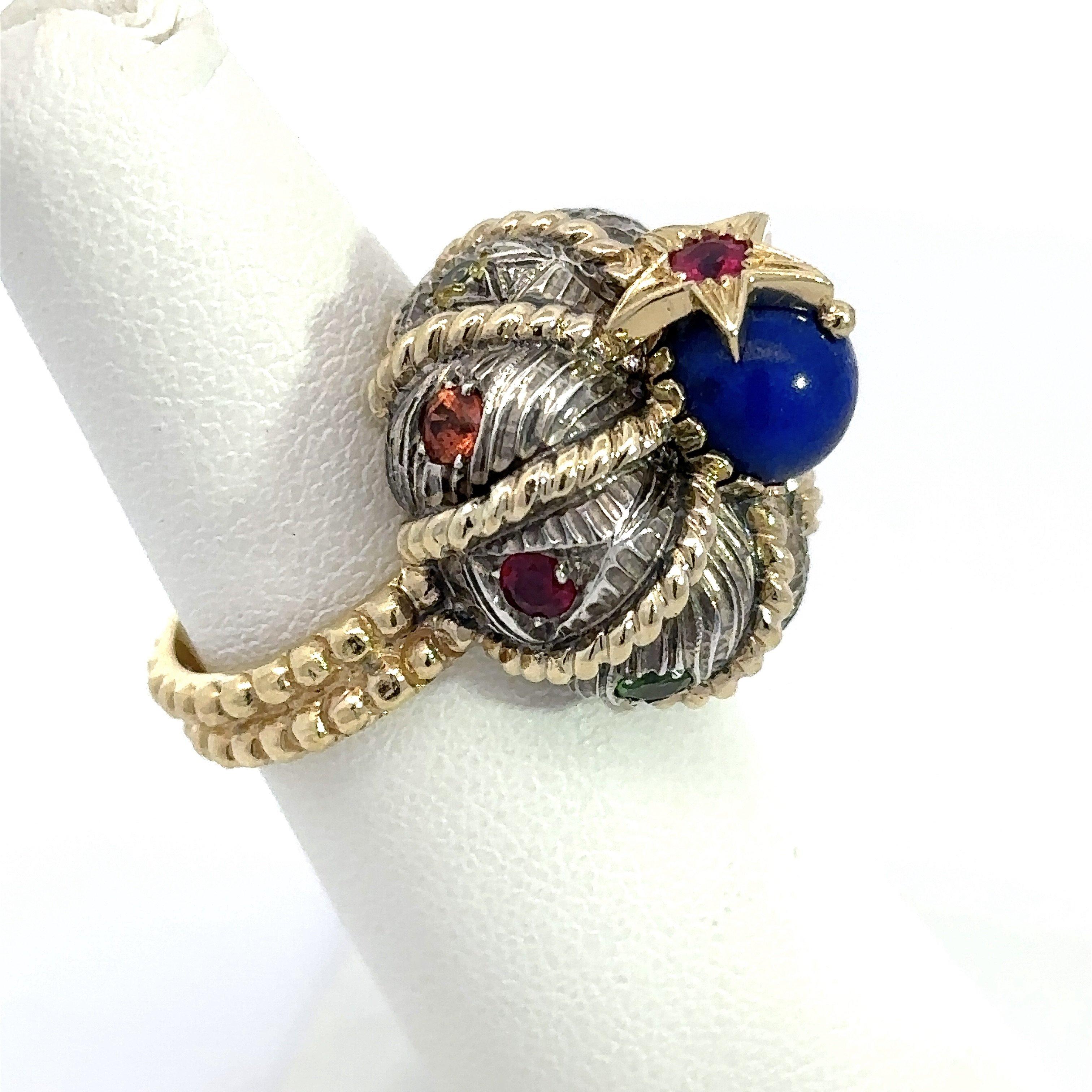 This signature Turban ring from Nardi Venice features a Moorish style turban crafted in sterling silver and 18KT yellow gold and surrounded by multi-color, flush-set gemstones. Atop the ring sits a lapis lazuli gemstone with a star as the crowning