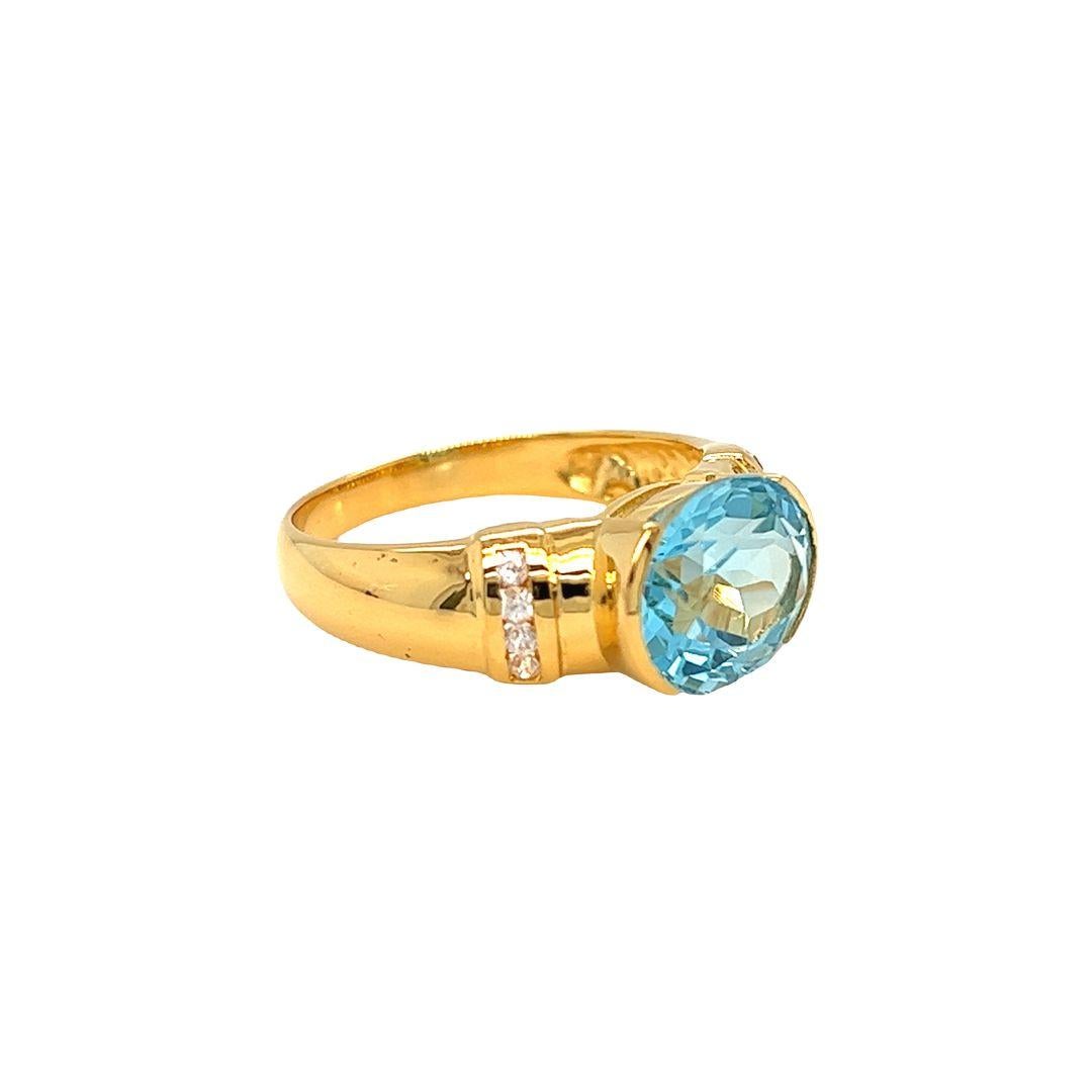14K Yellow Gold Fashion Ring featuring a stunning east-west half-bezel set oval Blue Topaz. The ring showcases a bold and perfectly blue oval Blue Topaz gemstone, measuring approximately 11 mm x 9 mm and weighing 4.5 carats.

A gorgeous oval-cut