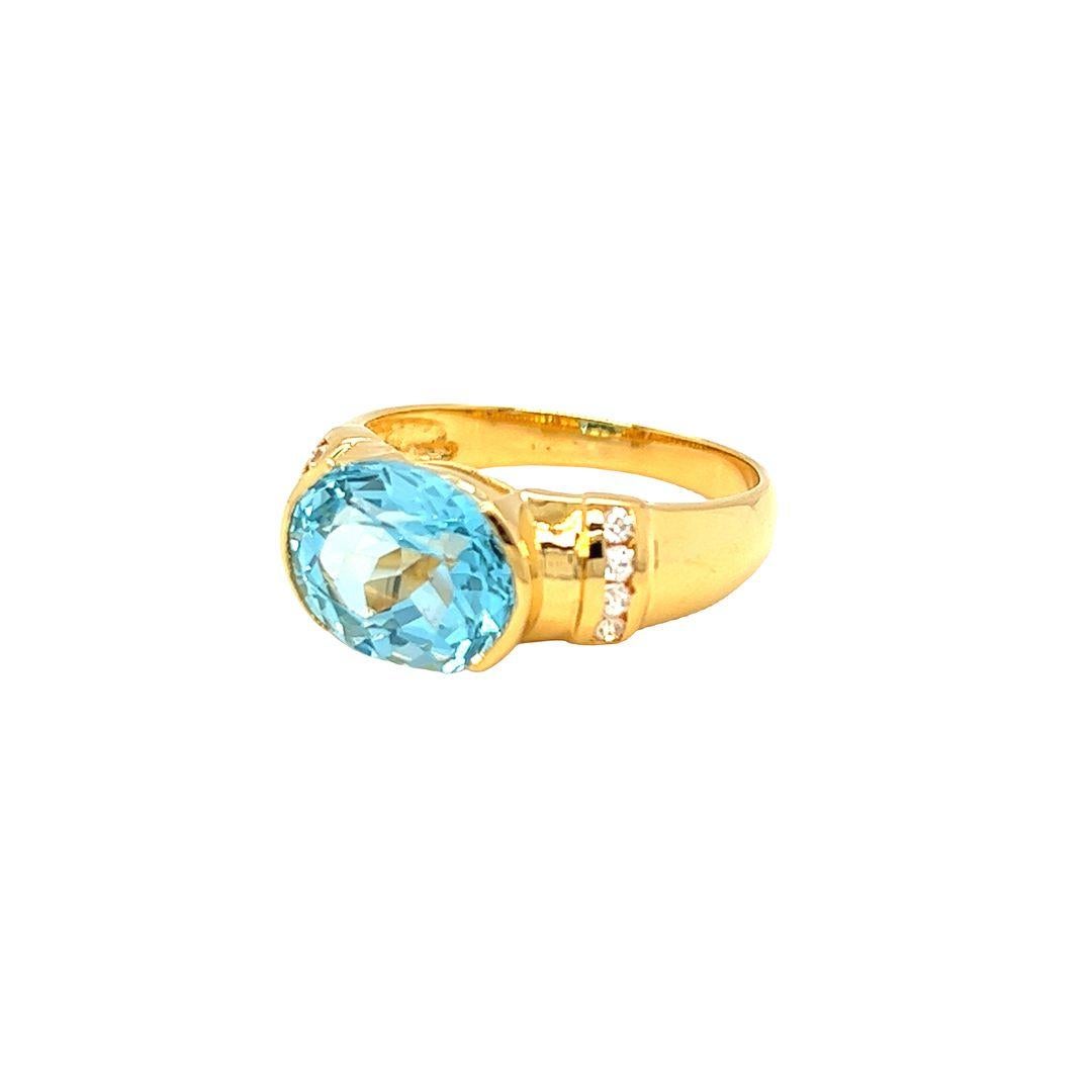 Contemporary Nari Fine Jewels Half Bezel Oval Blue Topaz and Diamond Ring 14K Yellow Gold For Sale