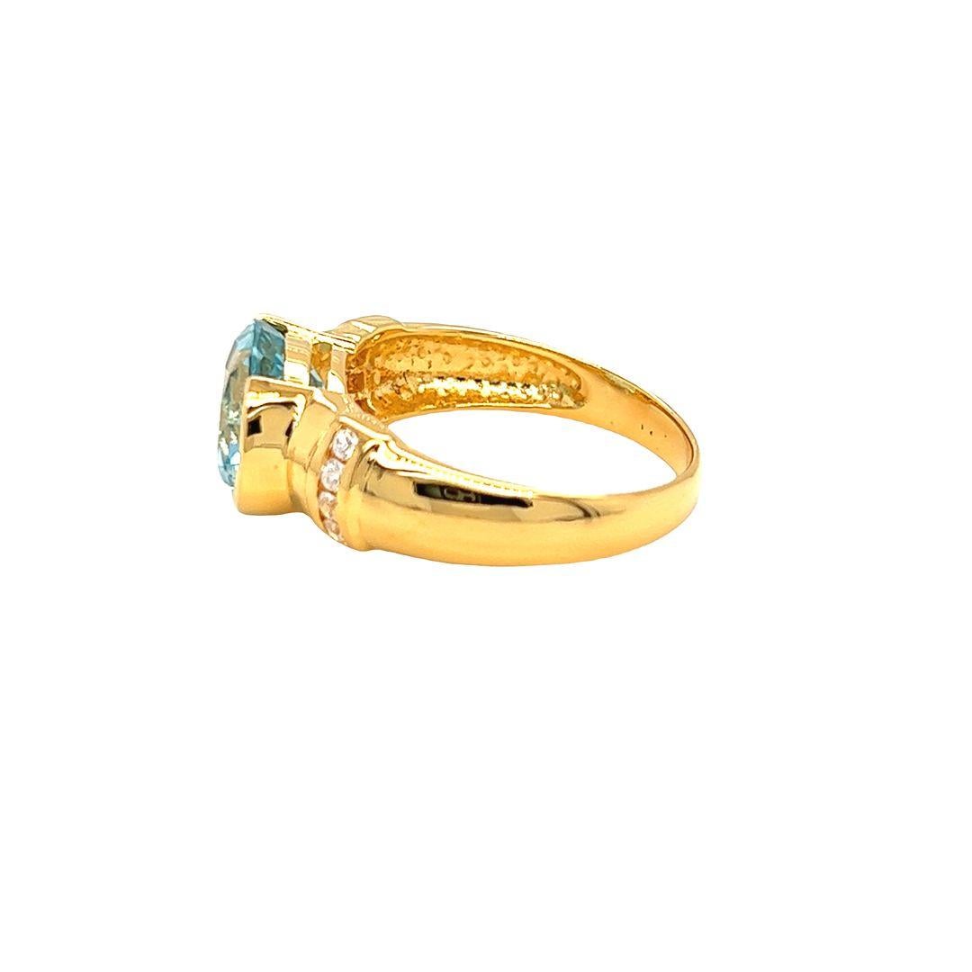 Oval Cut Nari Fine Jewels Half Bezel Oval Blue Topaz and Diamond Ring 14K Yellow Gold For Sale