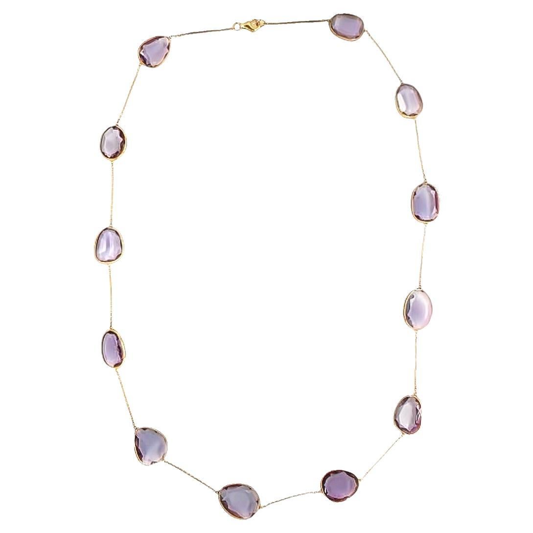 Lovely fancy shaped Amethyst is set in fine and feminine bezel setting to show off its vivid lilac color.  Handcrafted from the finest 18 karat yellow gold, this station necklace features twelve bezel-set, rose-cut multi-shaped Amethyst with a