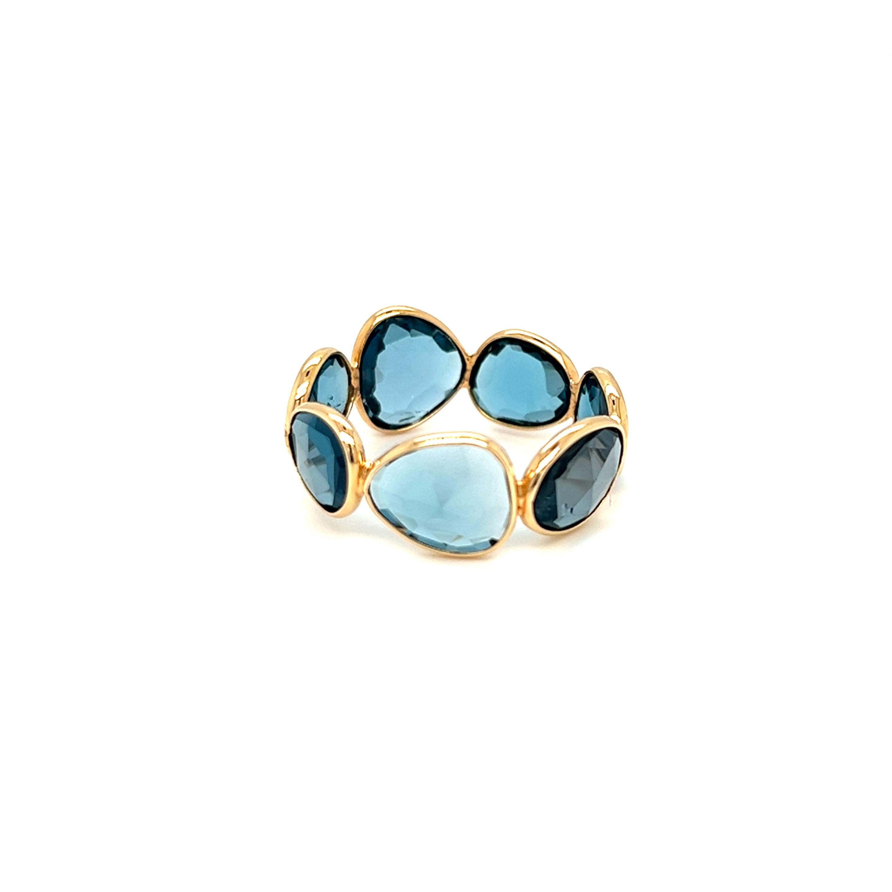Artistically handcrafted in 18K yellow gold, these beautiful one of a kind London Blue Topaz is hand set in simple bezel setting.  Total weight of the stones is 11 carats. The width of the band at the widest point is 10mm. The ring is in size 9.25