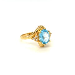 Nari Fine Jewels Oval Blue Topaz and Diamond Bypass Ring 14k Yellow Gold