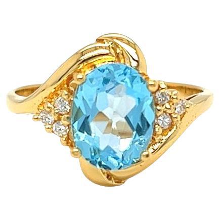 Nari Fine Jewels Oval Blue Topaz and Diamond Bypass Ring 14k Yellow Gold