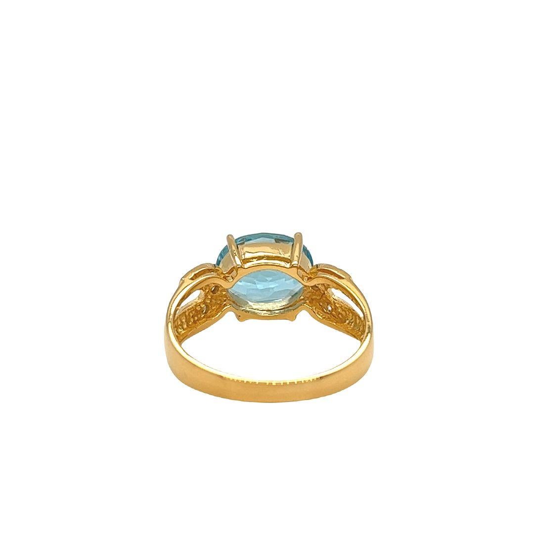 14K Yellow Gold Fashion Ring featuring a captivating east-west prong-set oval-cut Blue Topaz. The ring showcases a stunning oval Blue Topaz semi-precious gemstone, measuring approximately 10 mm x 8 mm and weighing 3 carats.

A gorgeous oval-cut Blue