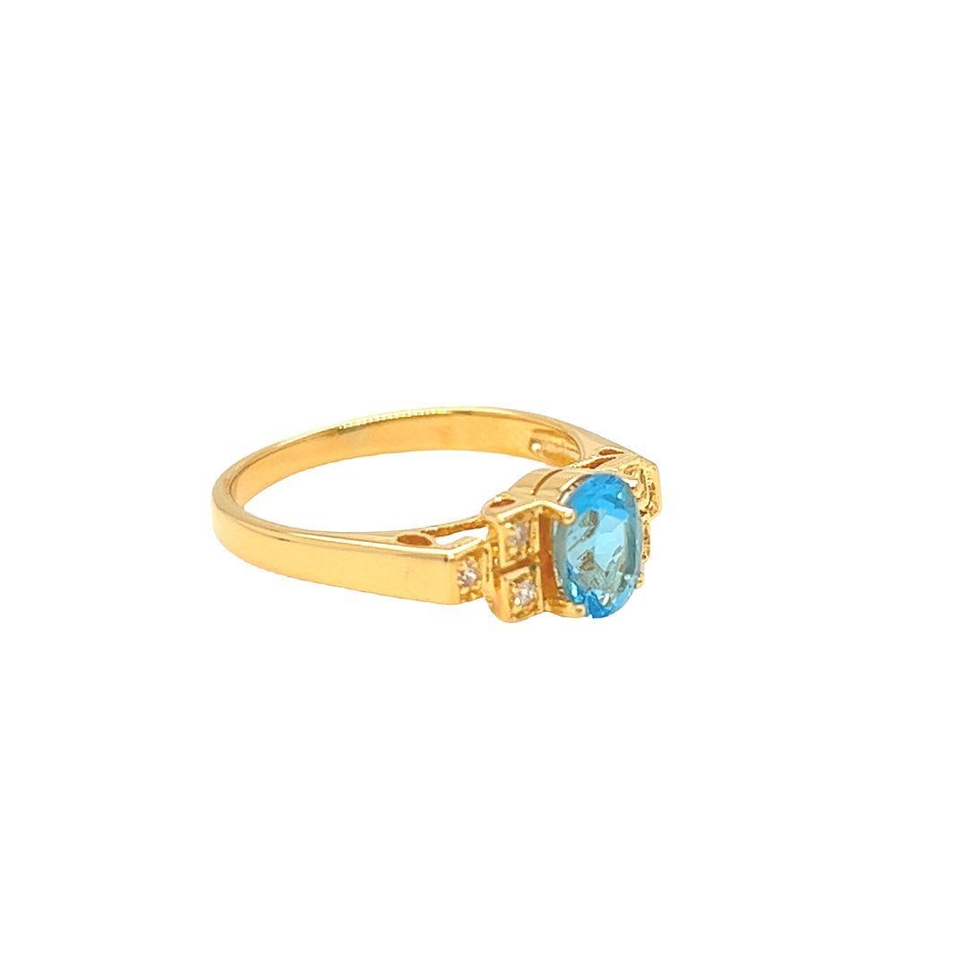 Crafted from 14K Yellow Gold, this oval Blue Topaz semi-precious gemstone measures 7 mm x 5 mm and has a total carat weight of 1 carat. Three round diamonds, set in square-shaped settings, flank a stunning Blue Topaz and total 0.06 carat.

The face