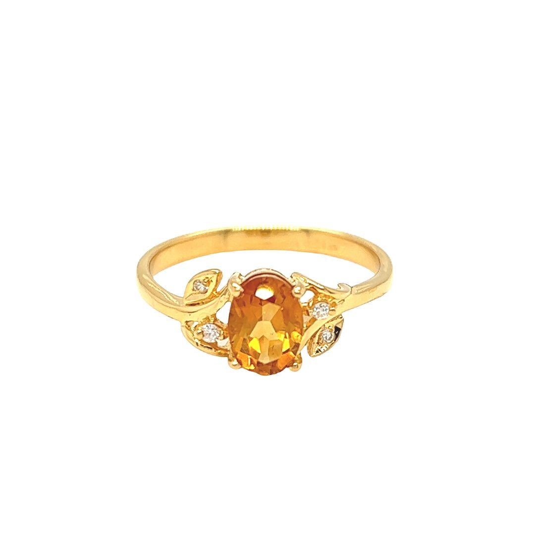 This 14K yellow gold Citrine ring features an eye-catching oval-cut Citrine with dimensions of 7 mm x 5 mm and a weight of 0.90 carats. Accenting this bold, warm-toned center stone is a series of vine-like designs on the shank with petite