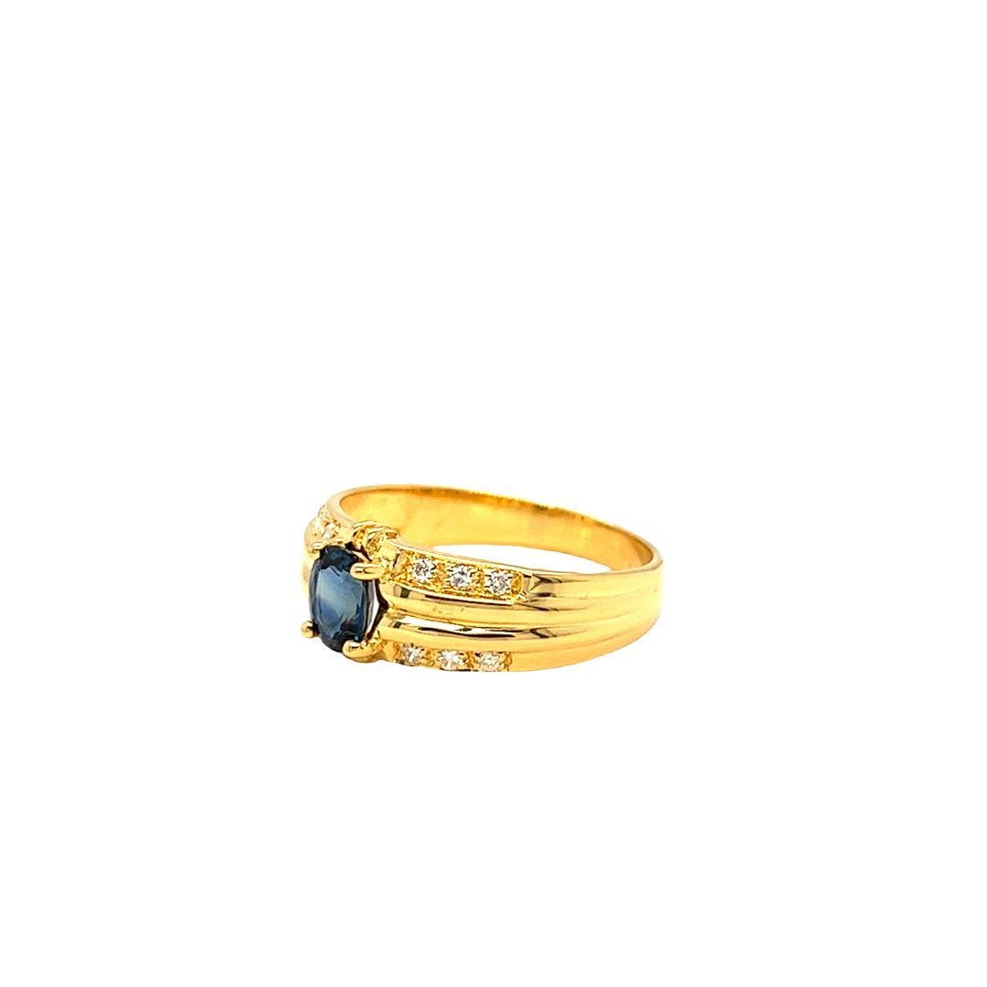 14K Yellow Gold Fashion Ring featuring a stunning prong set Blue Sapphire atop a luxuriously ribbed shank with diamonds. The ring showcases a bold vibrant blue oval sapphire, measuring approximately 6 mm x 4.5 mm and weighing 0.40 carats.

A