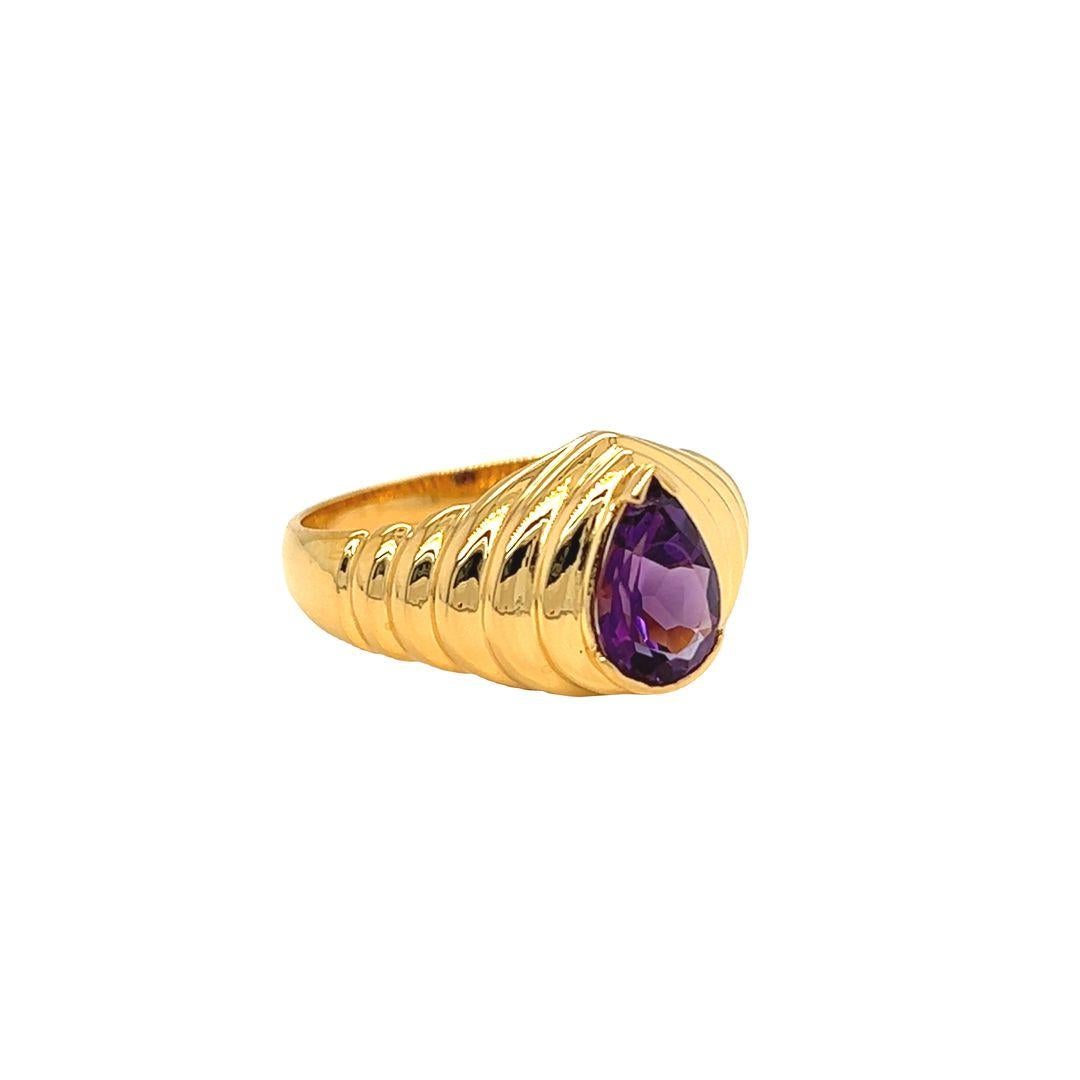 Be bold and beautiful with this stunning 1.75 carat pear-shaped amethyst ring, crafted by Nari Fine Jewels in 14k gold for a luxurious look. Its ribbed texture and fluted edges present a unique and eye-catching statement. Indulge in timeless