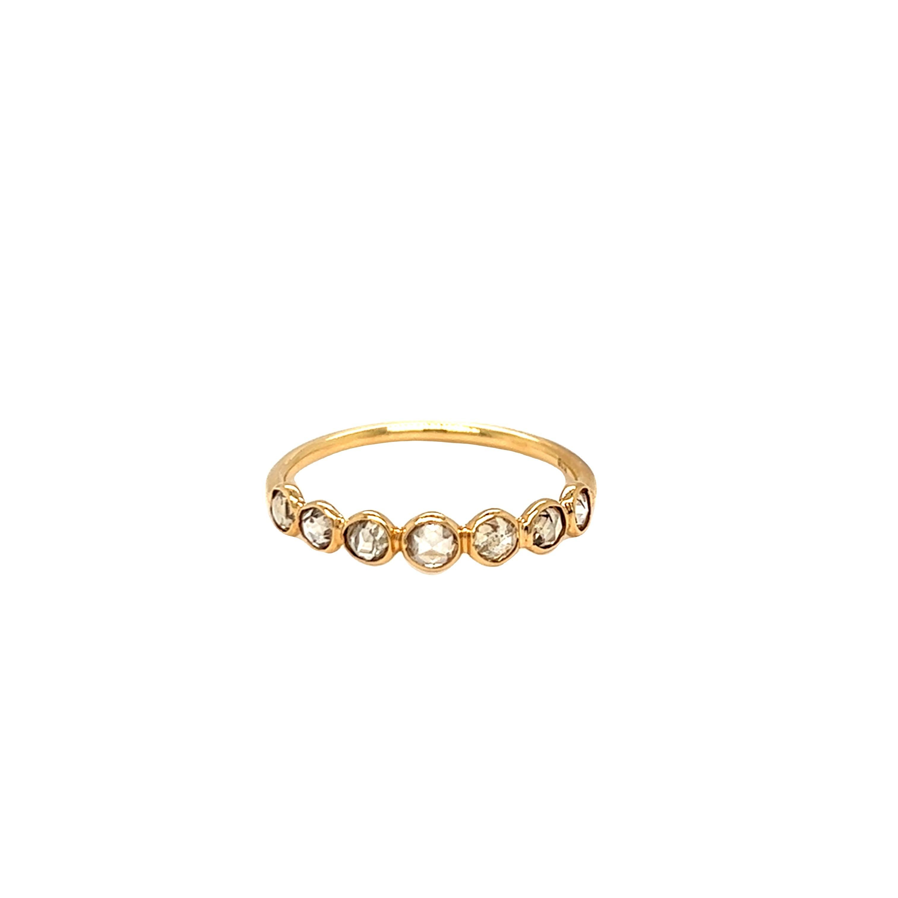 Handcrafted in 18K yellow gold by Nari Fine Jewels in Beverly Hills, CA, this beautiful half eternity ring band has 7 rose cut Cognac diamonds weighing 0.65 carat.  The ring is currently in size 7 and can be resized. 
