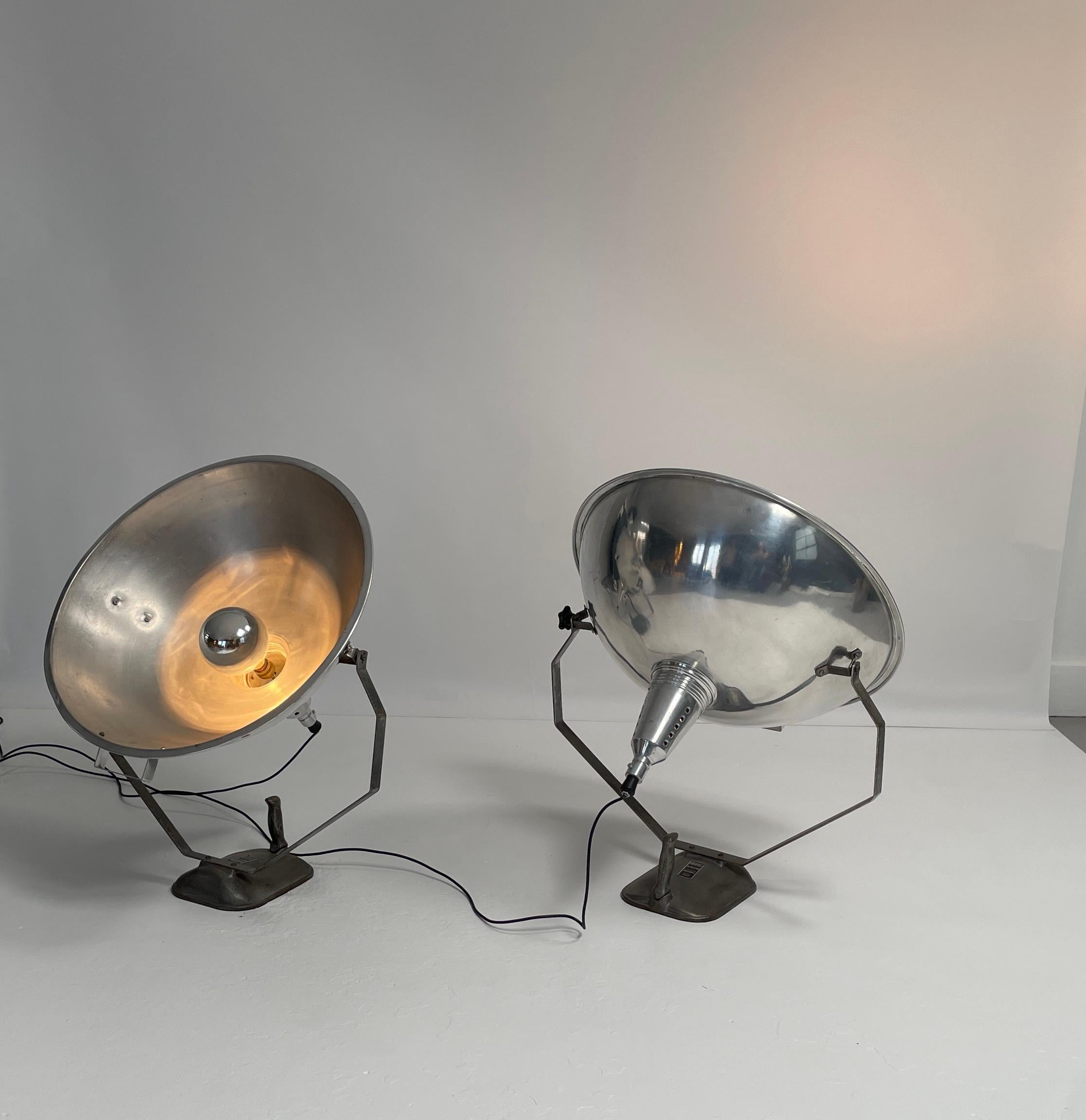 Two unique lights. These projector lamps were from French movie studios in Paris. They hold a lot of historical importance. They heads pivot and the bulbs can be adjusted with in the housing. They are not only practical lighting source but a great