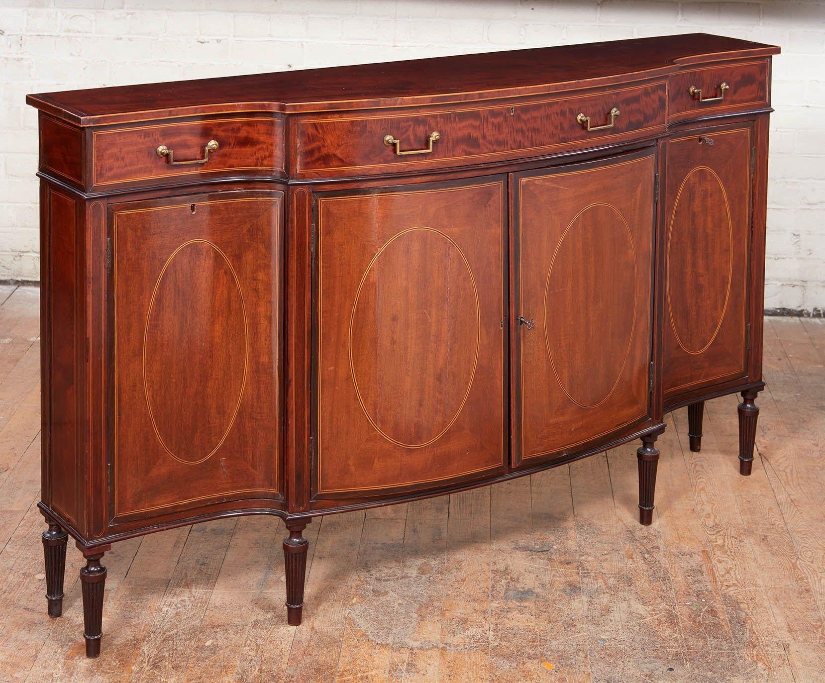 Fine George III style inlaid mahogany credenza of unusually narrow size by leading London manufacturers Wright and Mansfield, having rosewood and holly crossbanded top over bank of drawers with original brass hardware over four cabinet doors with