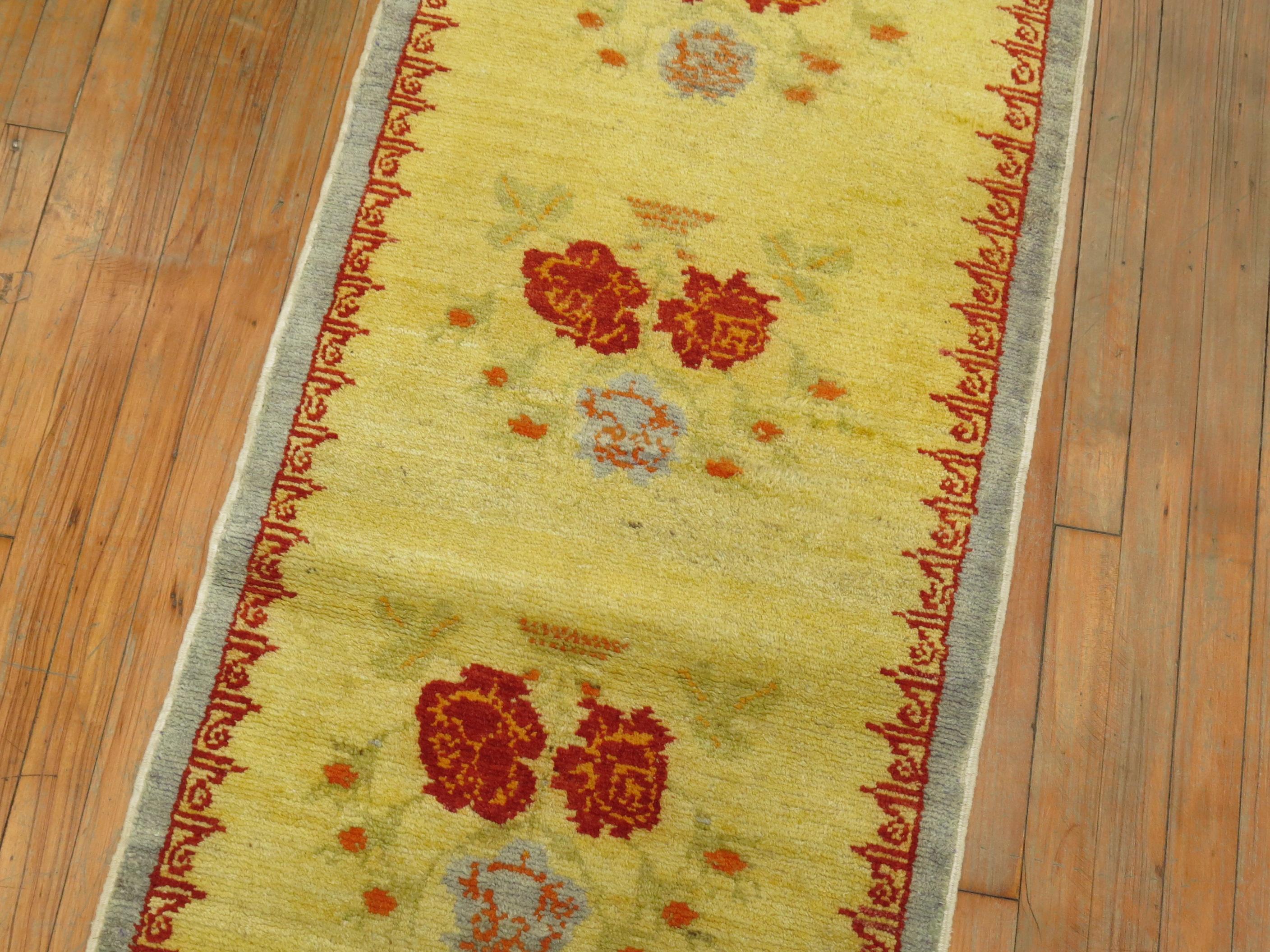 A one of a kind Turkish runner with running flowers on a bright yellow ground.