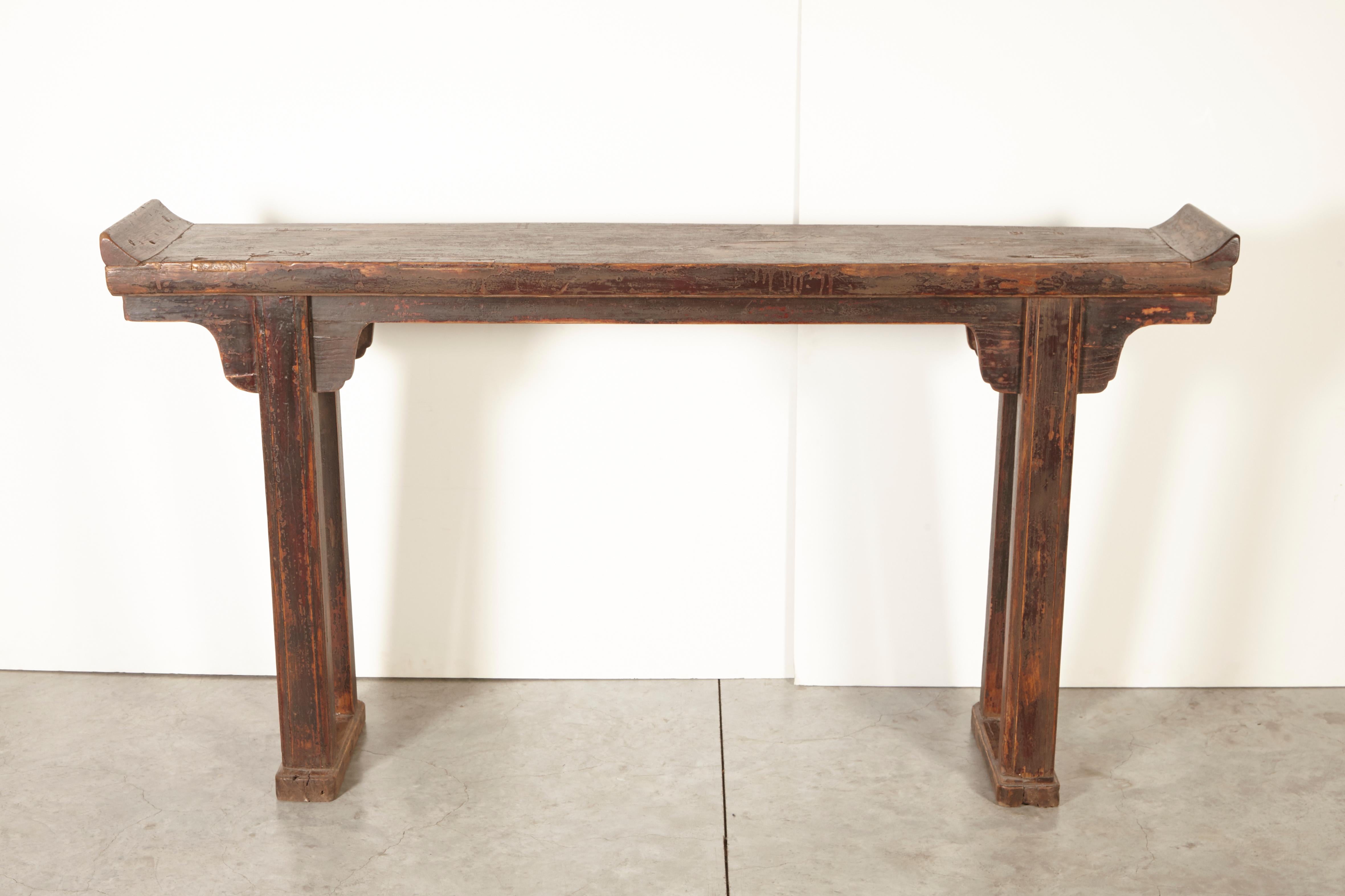 A classically designed 19th century Chinese elm altar table with clean lines and a beautiful patina that display it’s many years of use. It’s narrow profile makes it very useful as an entryway piece or behind a sofa. From Shanxi Province.