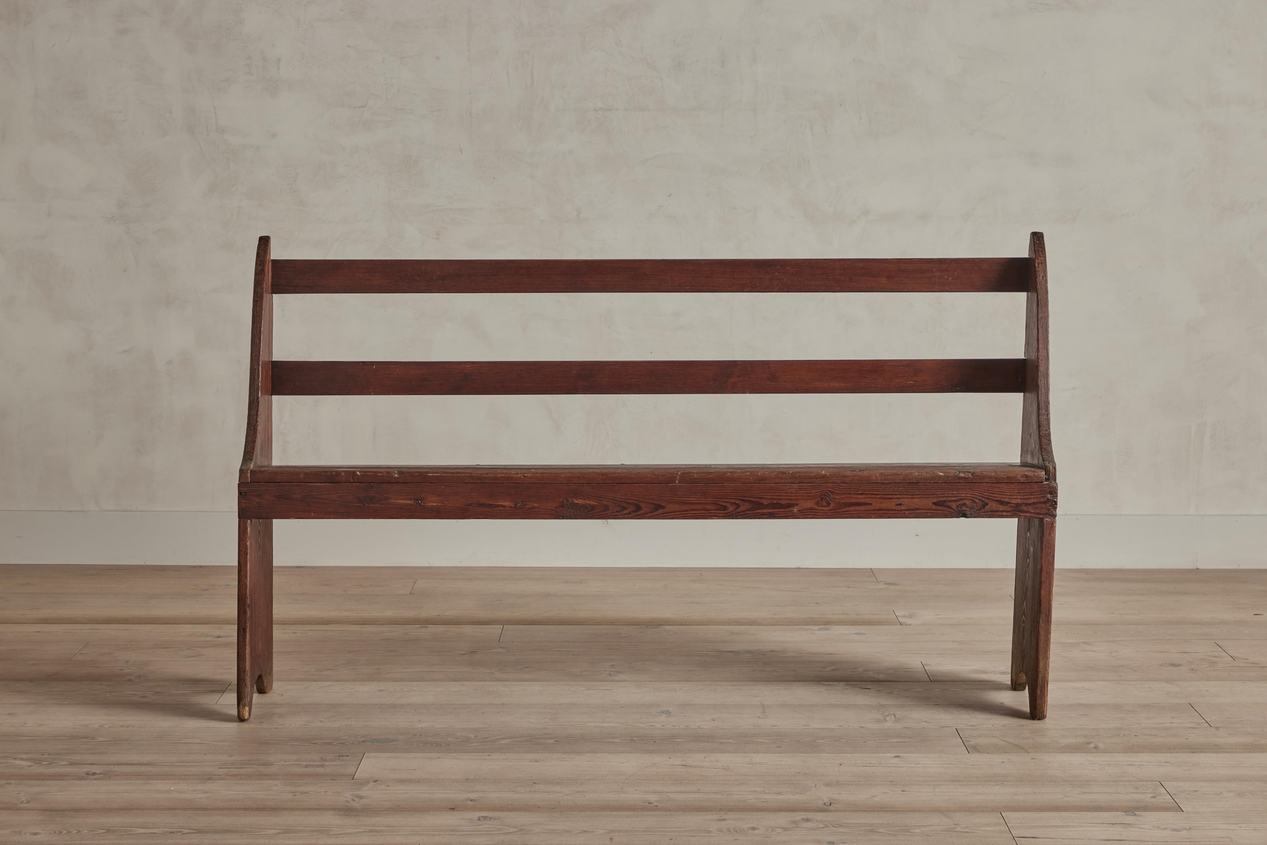 Narrow rustic wood church bench from Virginia circa 1880. Wear throughout wood is consistent with age and use.