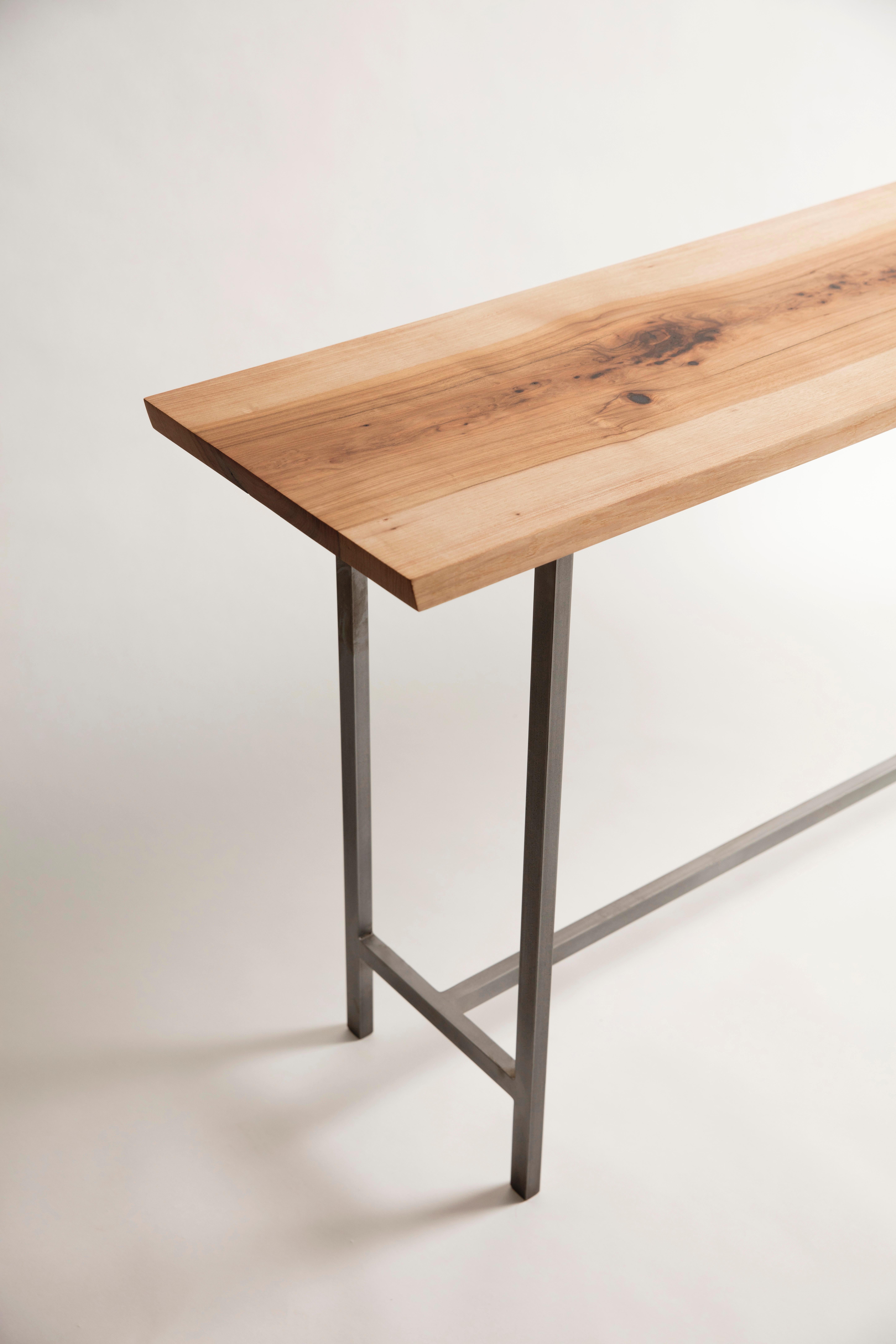 We call our narrow console table in solid wood and modern steel base the 