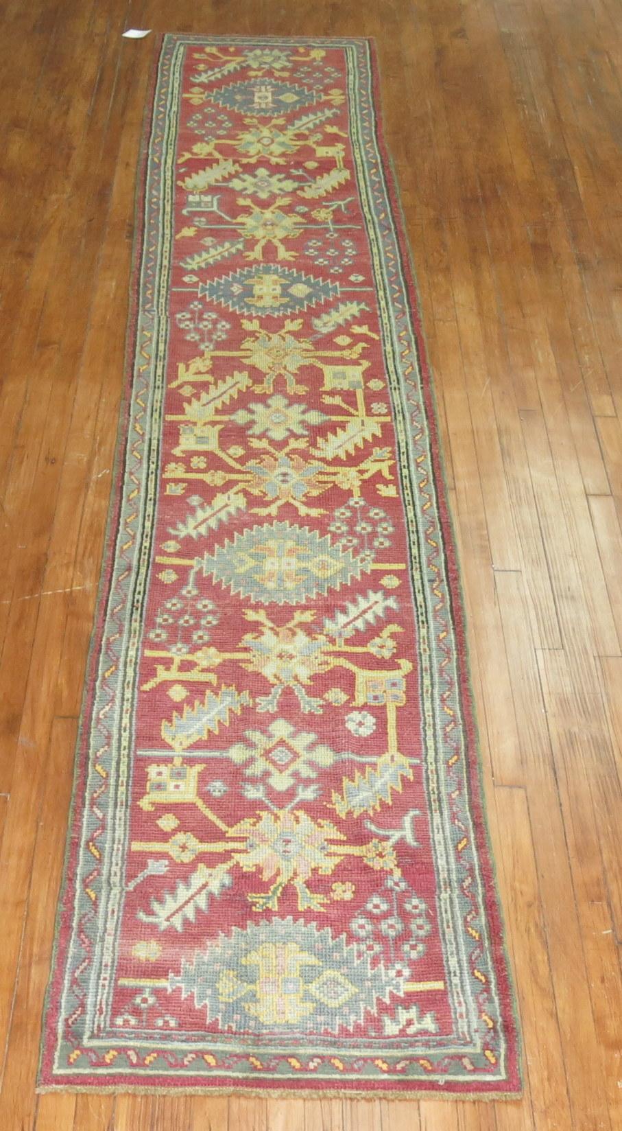 Antique Turkish Oushak runner with multiple medallions on a dark red field, circa 1910.

Measures: 2'5'' x 13'6''.