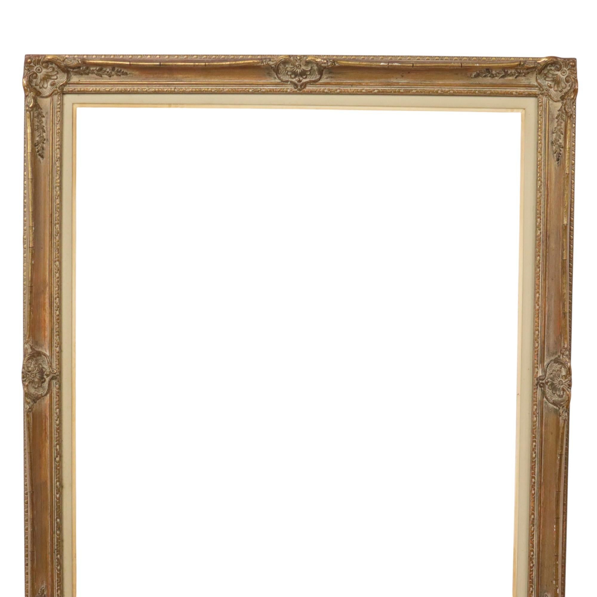 Narrow gold-colored pine frame with a beautiful patina of age, entirely in classic Baroque style, decorated with elegant acanthus leaves, tendrils, and patterns. This vintage piece dates from the first to mid-20th century.

A great size frame for