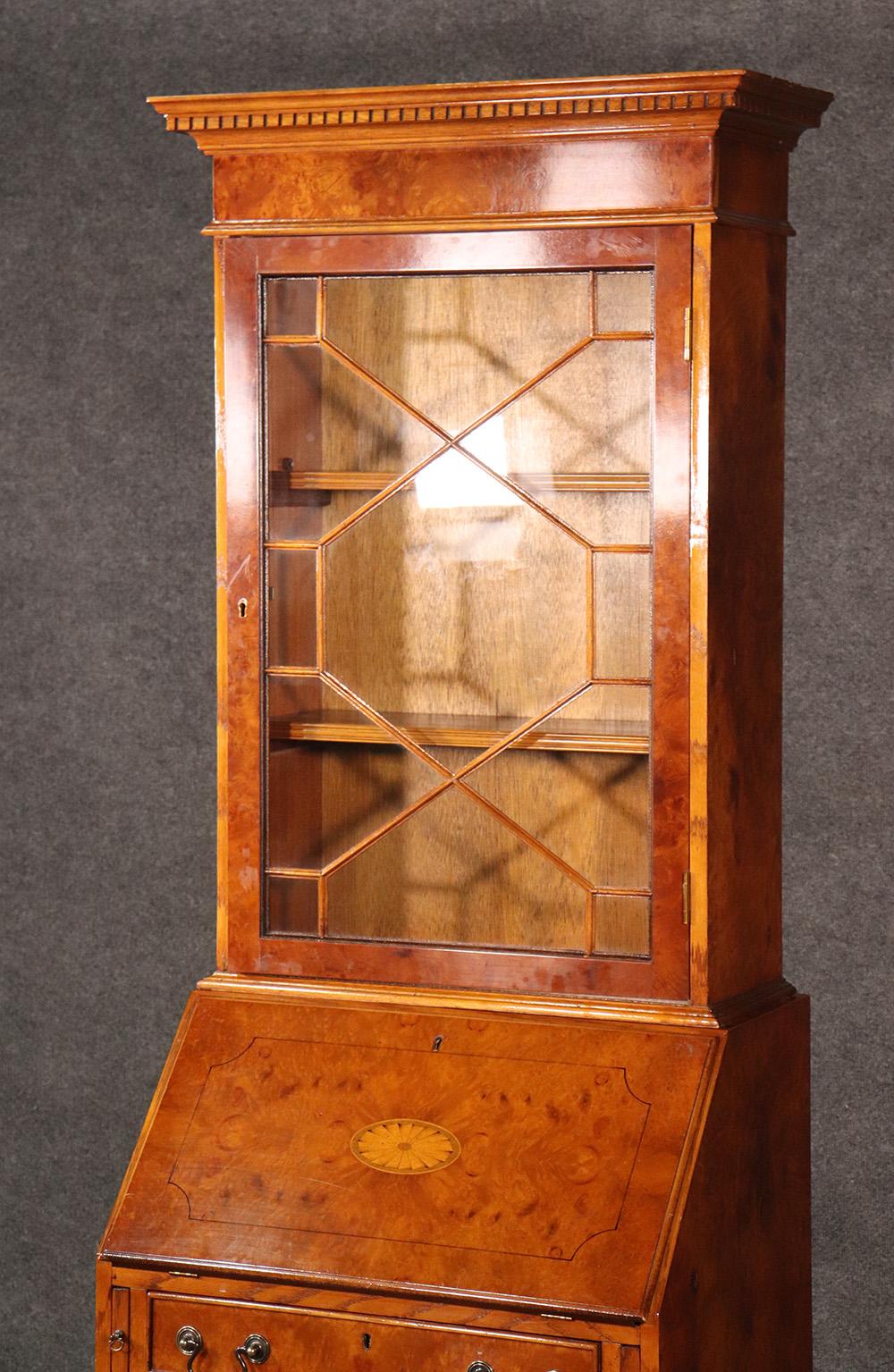 This is a gorgeous English narrow secretary desk, circa 1950. The desk can fit anywhere! I mean look at the width of this piece! This burled walnut and satinwood two-piece desk is designed in the English Georgian manner and dates to the 1940s era.