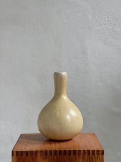 Narrow long necked vase in yellow glaze by Eva Stæhr Nielsen for Saxbo, Denmark
