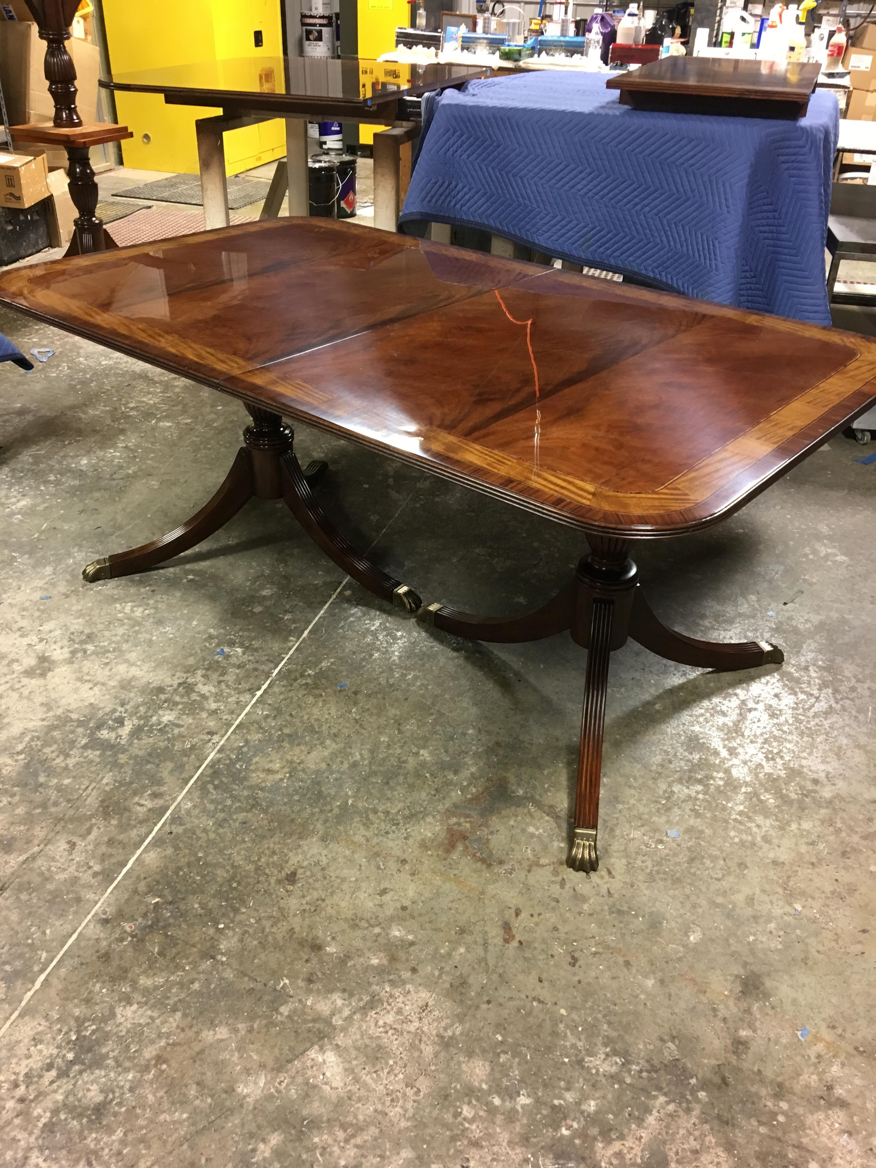 This is a made-to-order Large Traditional mahogany banquet/dining table made in the Leighton Hall shop. It features a field of slip-matched swirly crotch mahogany from west Africa and movingue and santos rosewood borders from South America. The
