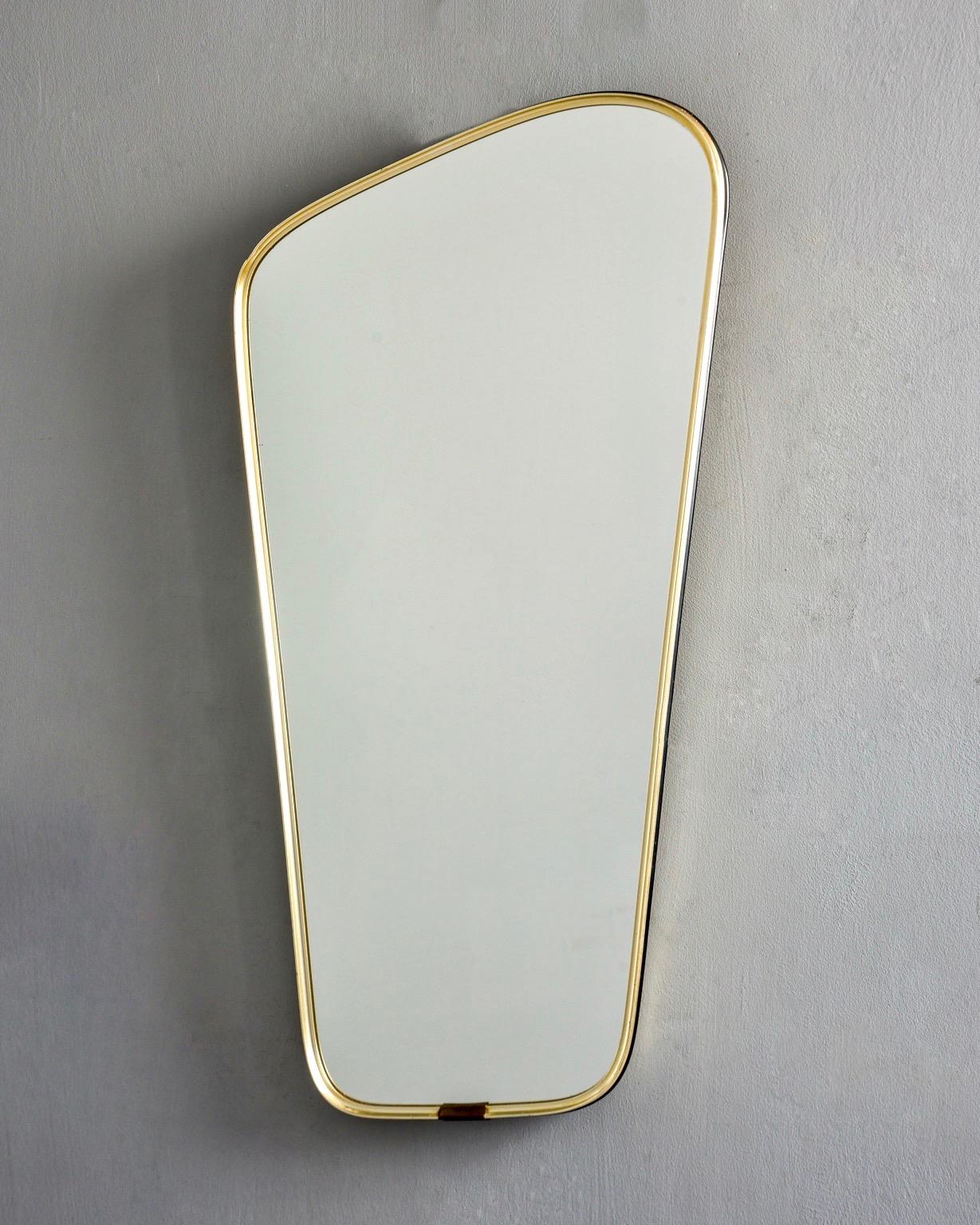 Found in Italy, this circa 1960s mirror has a narrow brass frame and oblong shape in style of Gio Ponti. Unknown maker and designer. 

Some minor black spots to mirror.