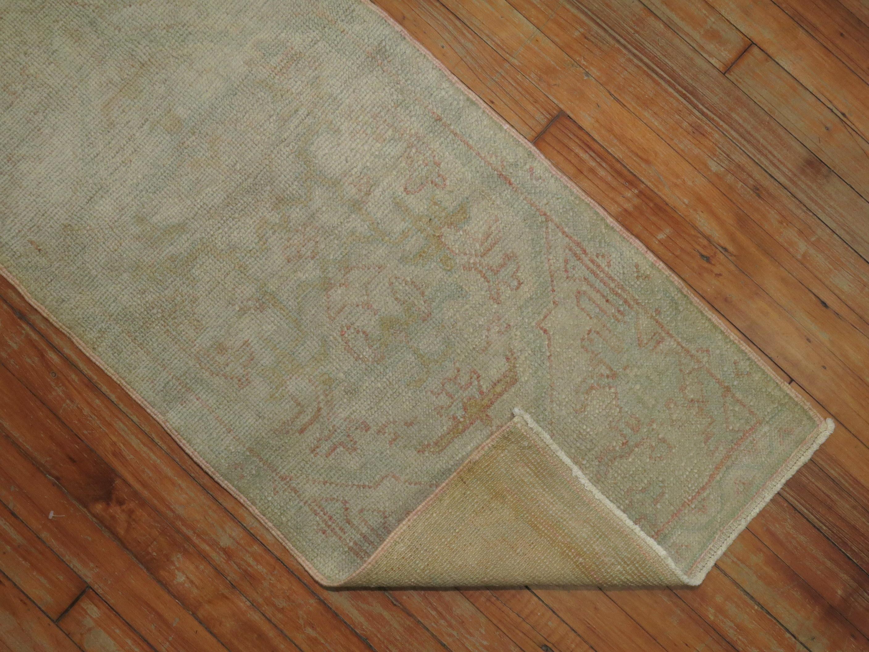 Pale one of a kind early 20th century Turkish Oushak runner with a subdued palette in cream and pink. 

 measures: 1'10