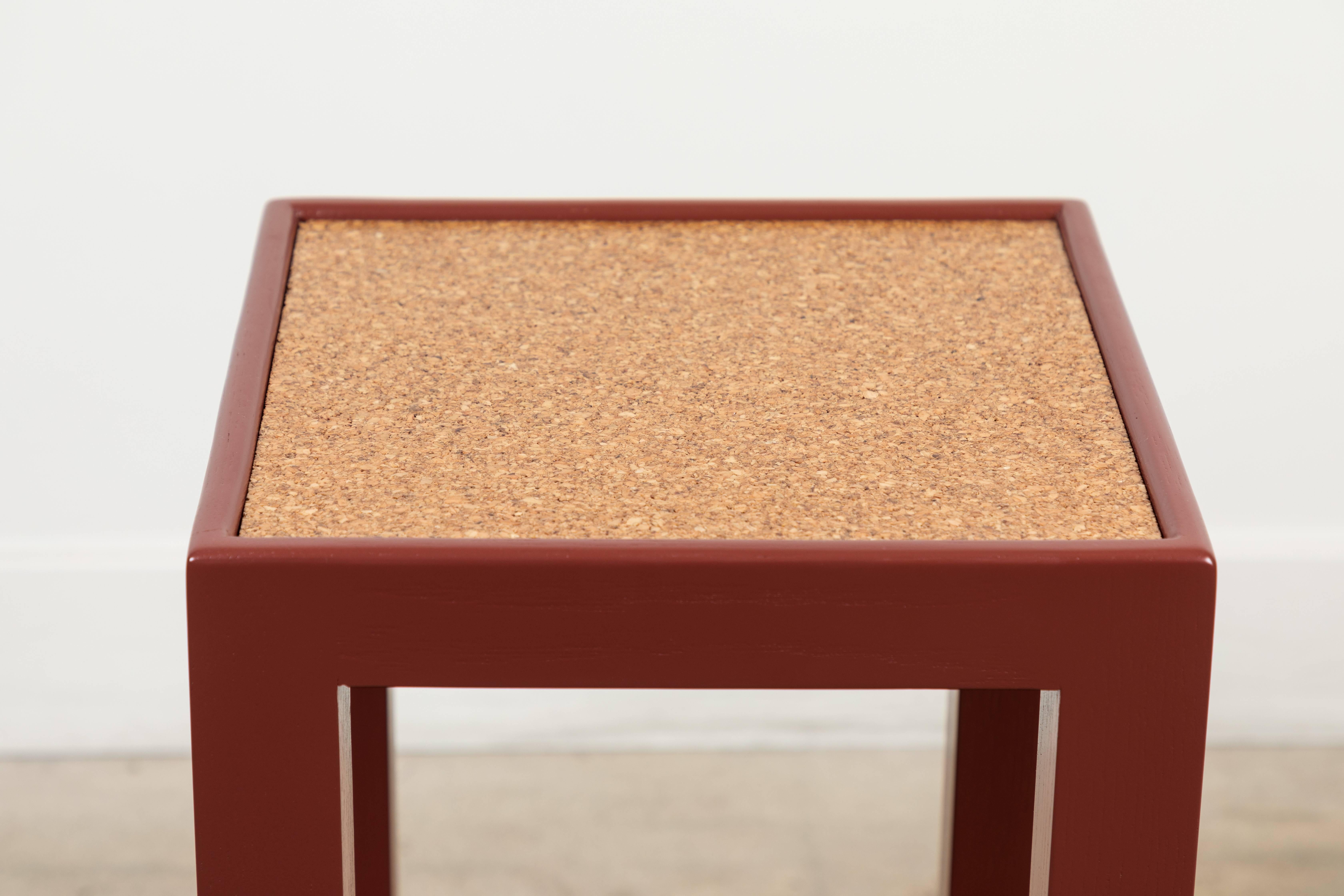 The Narrow Side Table is made of solid American walnut or white oak and features a lower shelf and your choice of a cork or bronze mirror top. Shown here in Burnt Russet Pigmented Oak and cork. 

Made to order in various finishes with a 10-12 week