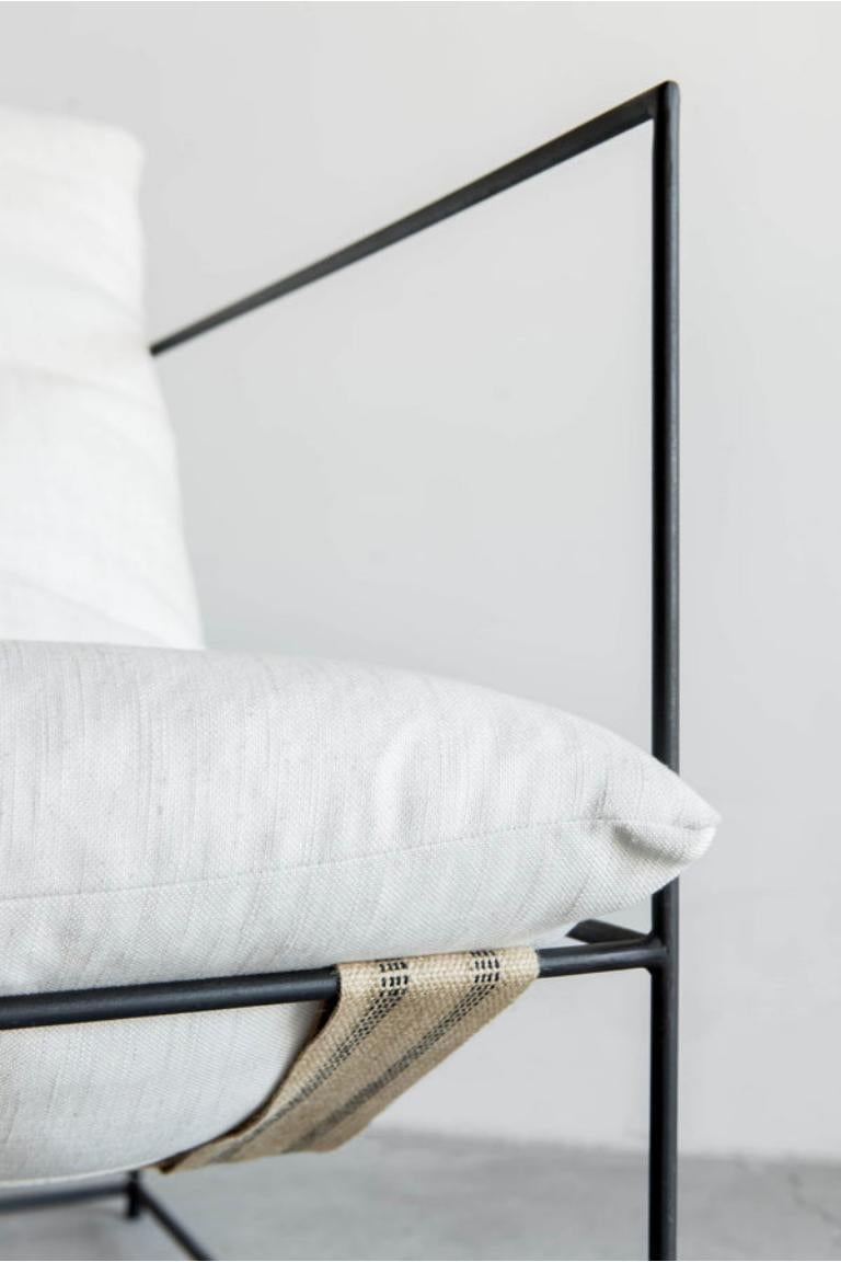 The Narrow Sierra Chair is handmade locally in Los Angeles, California. flagship upholstered piece is regarded for not only its distinct design, but its exceptional comfort as well. An open, thin steel frame allows the design to incorporate negative