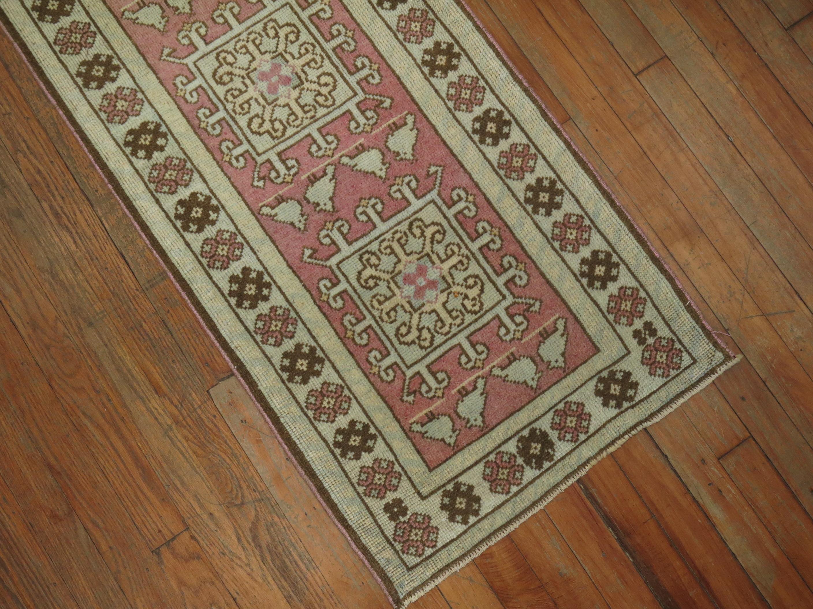 Mid-20th century Turkish runner in predominant soft pink. Narrow and long. Measures: 1'11” x 14'1”.