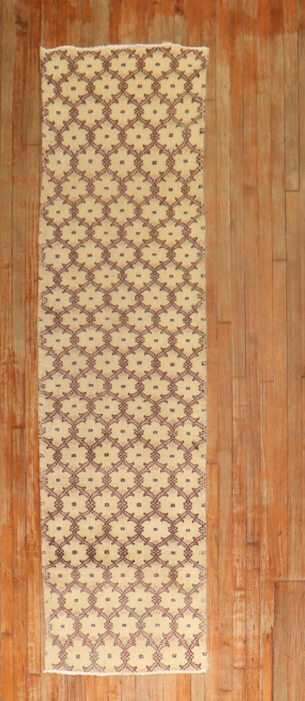 One of a kind decorative Vintage Turkish Konya runner with a repetitive borderless motif in soft pink on a creamy yellow field

Measures: 2'4'' x 9'3''.