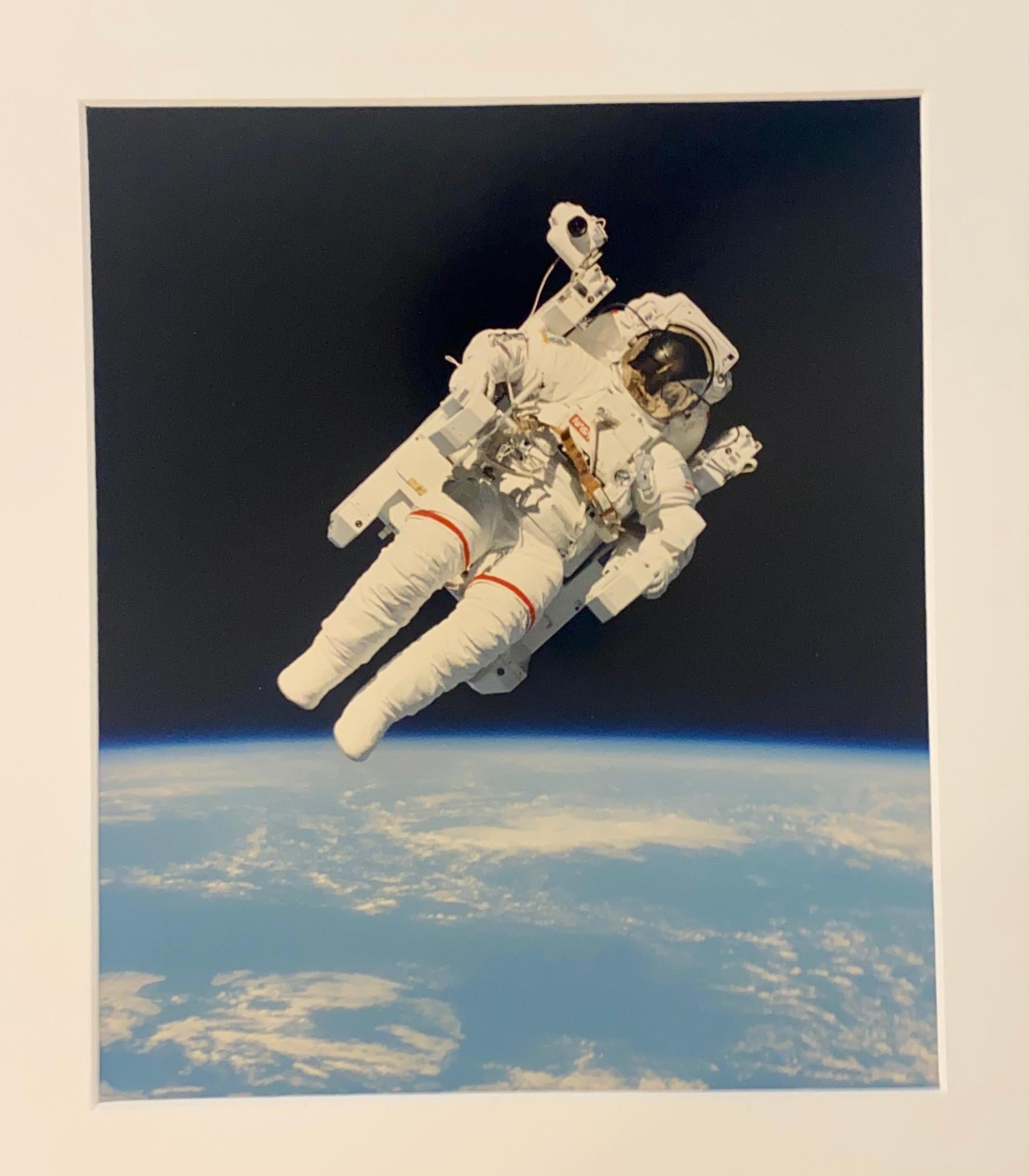 Historic portrait photography of the first man to fly untethered in space. Above the earth in 1984, NASA Astronaut Bruce McCandless and his Manned Maneuvering Unit (MMU). 

Crewmembers aboard the space shuttle Challenger nearby used a 70mm camera to