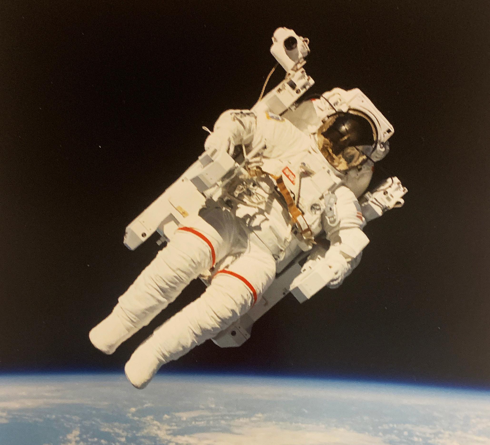 Historic portrait photography of the first man to fly untethered in space. Above the earth in 1984, NASA Astronaut Bruce McCandless and his Manned Maneuvering Unit (MMU). 

Crewmembers aboard the space shuttle Challenger nearby used a 70mm camera to