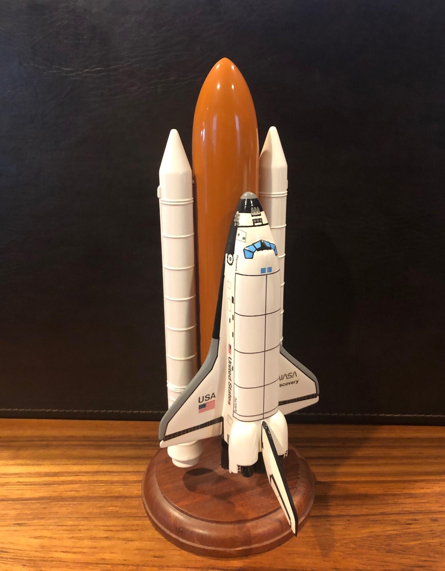 A very cool NASA Space Shuttle Discovery contractor desk model, circa 1990s. The piece is in very good condition and is made of a plastic and wood and mounted on a 5